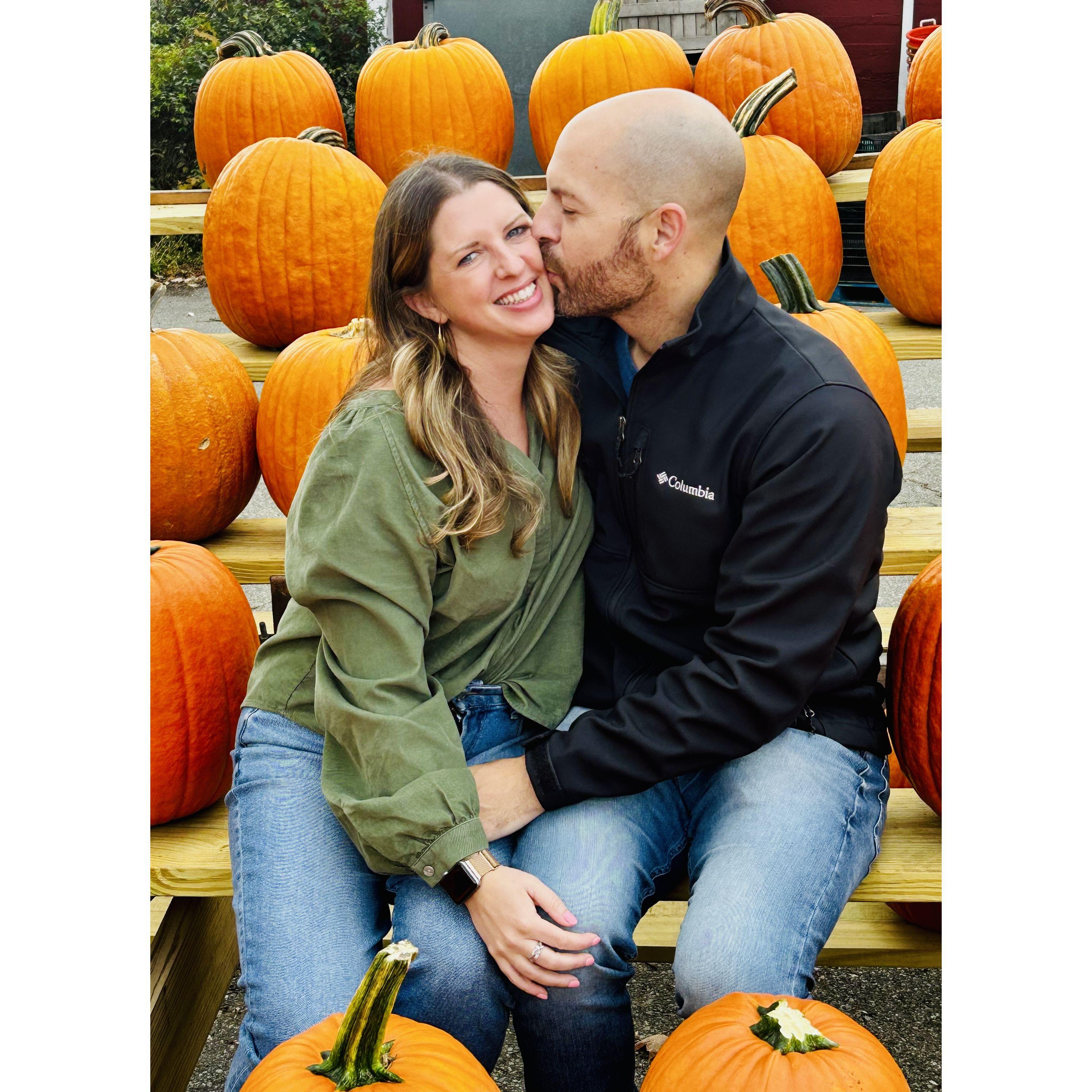 Jon distracting Jenn from recognizing his head looks just like a pumpkin.
