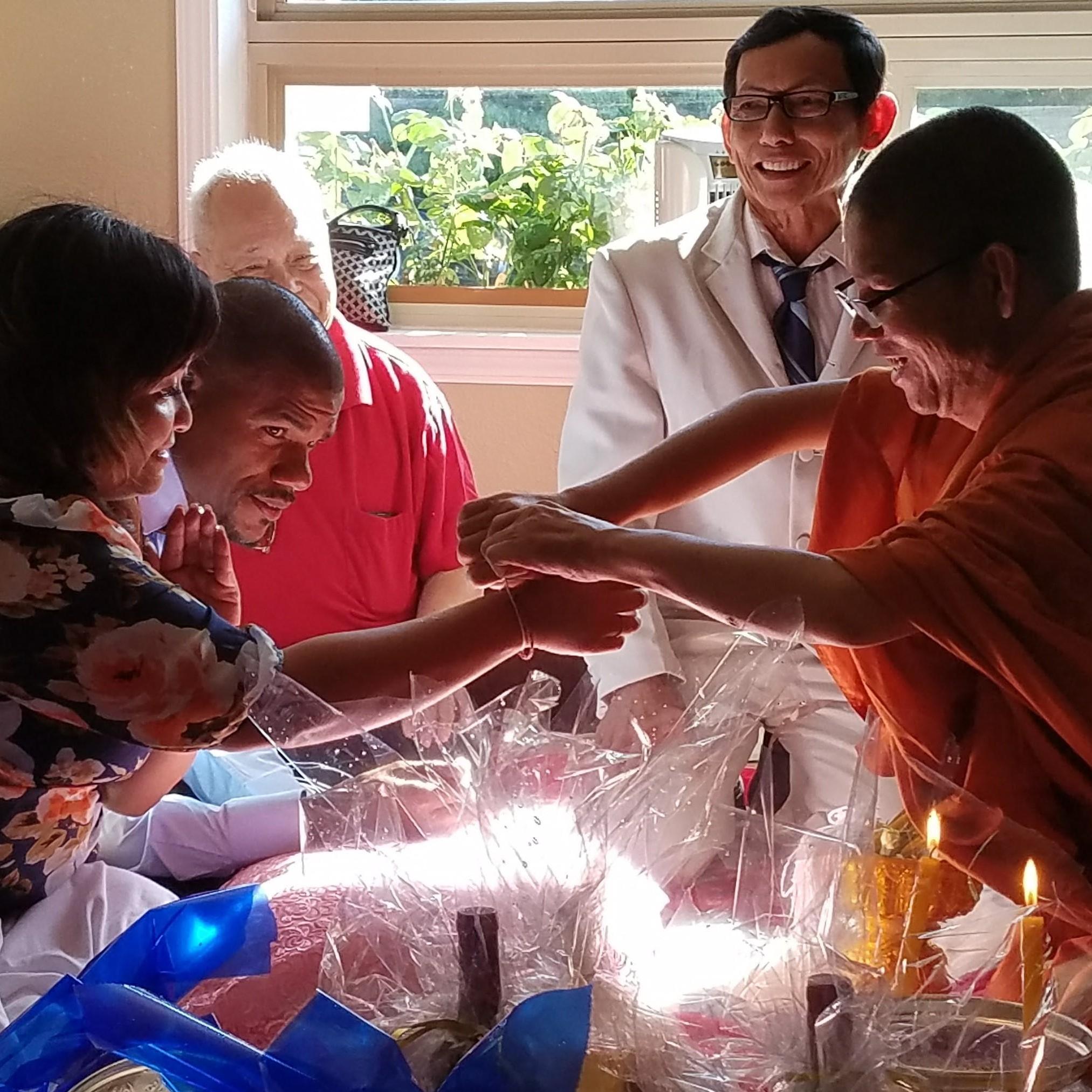 We're getting blessed by the Buddhist Monk.