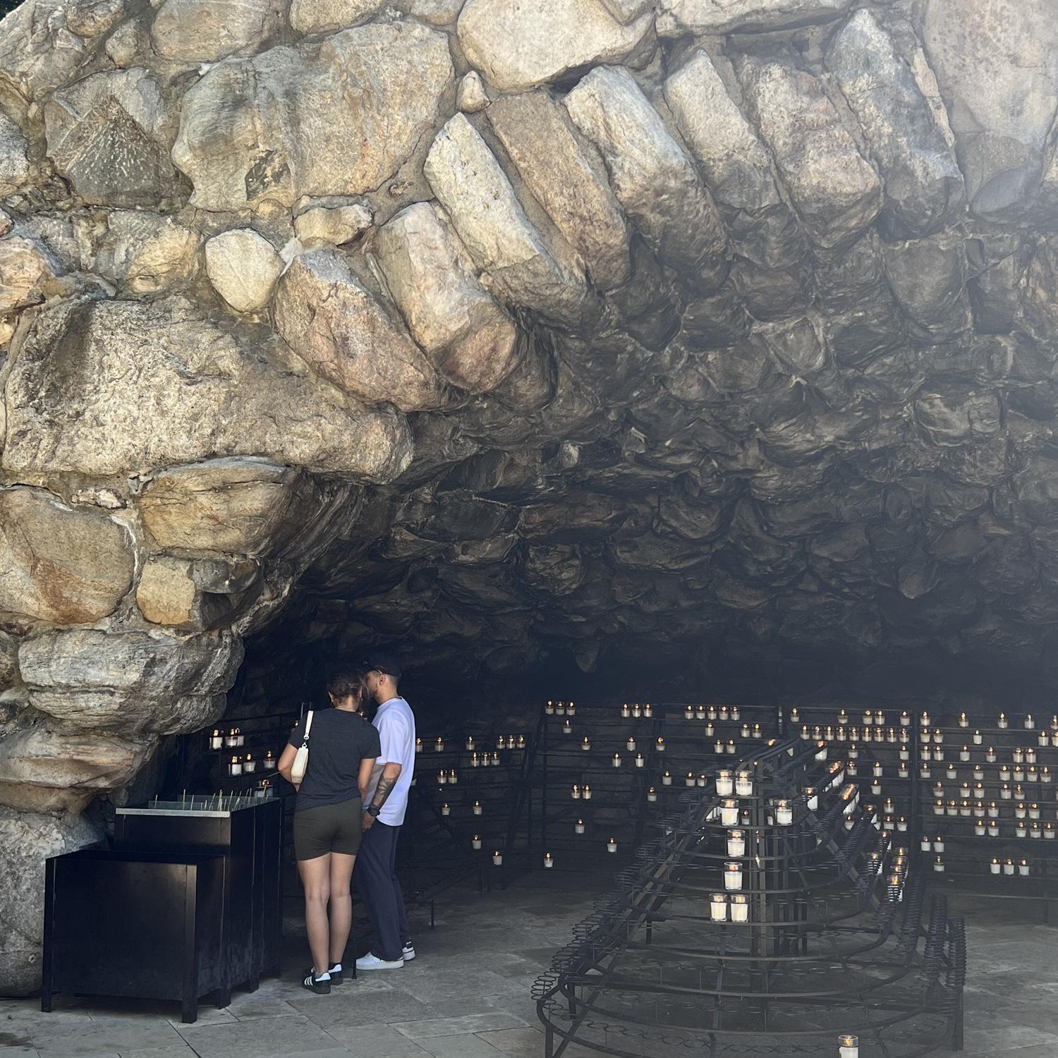 Maia showing Daniel around her old campus at the University of Notre Dame. Lighting a candle at the grotto