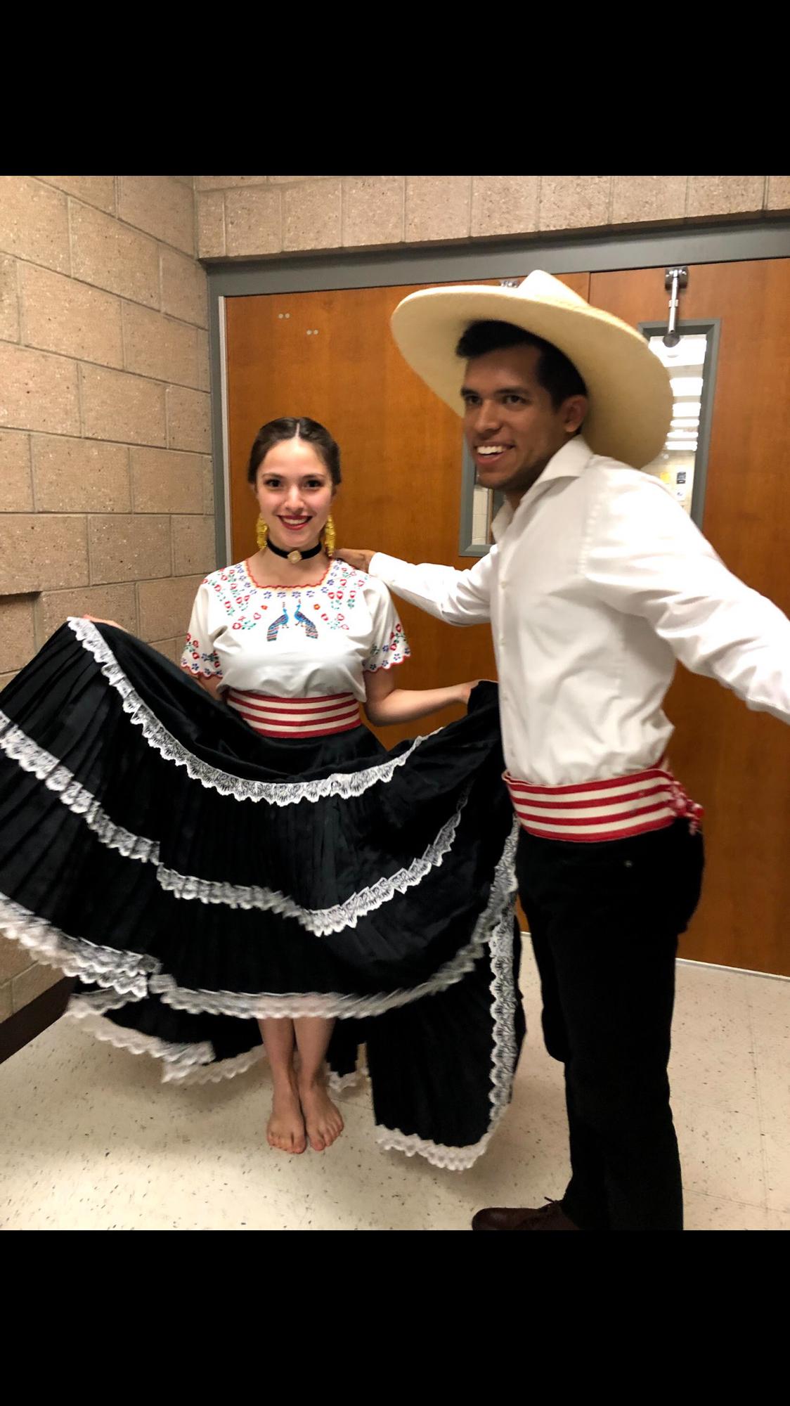 A close up of a younger Samantha and Miguel in traditional Marinera Norteña clothing.