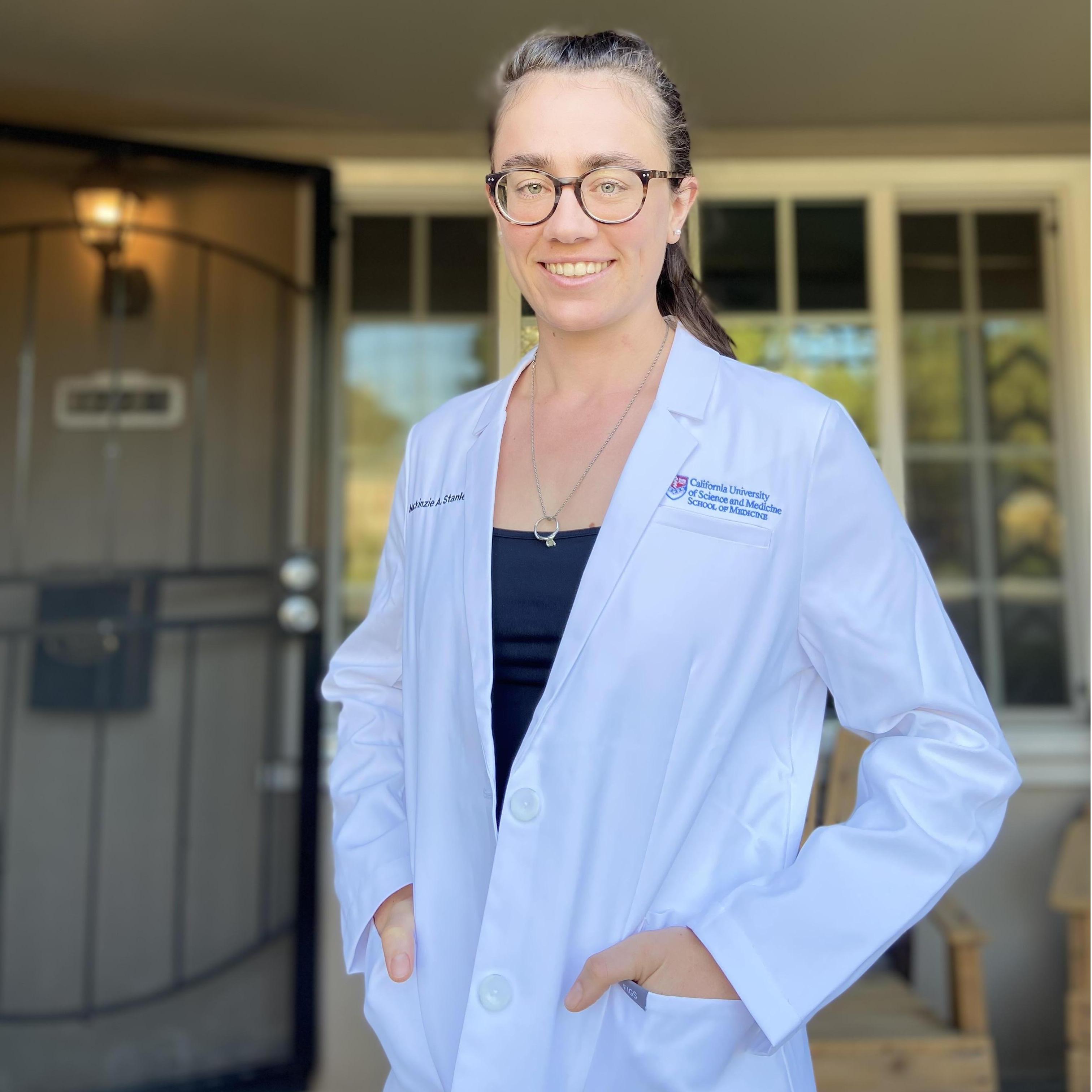 Showing off her customized white coat!