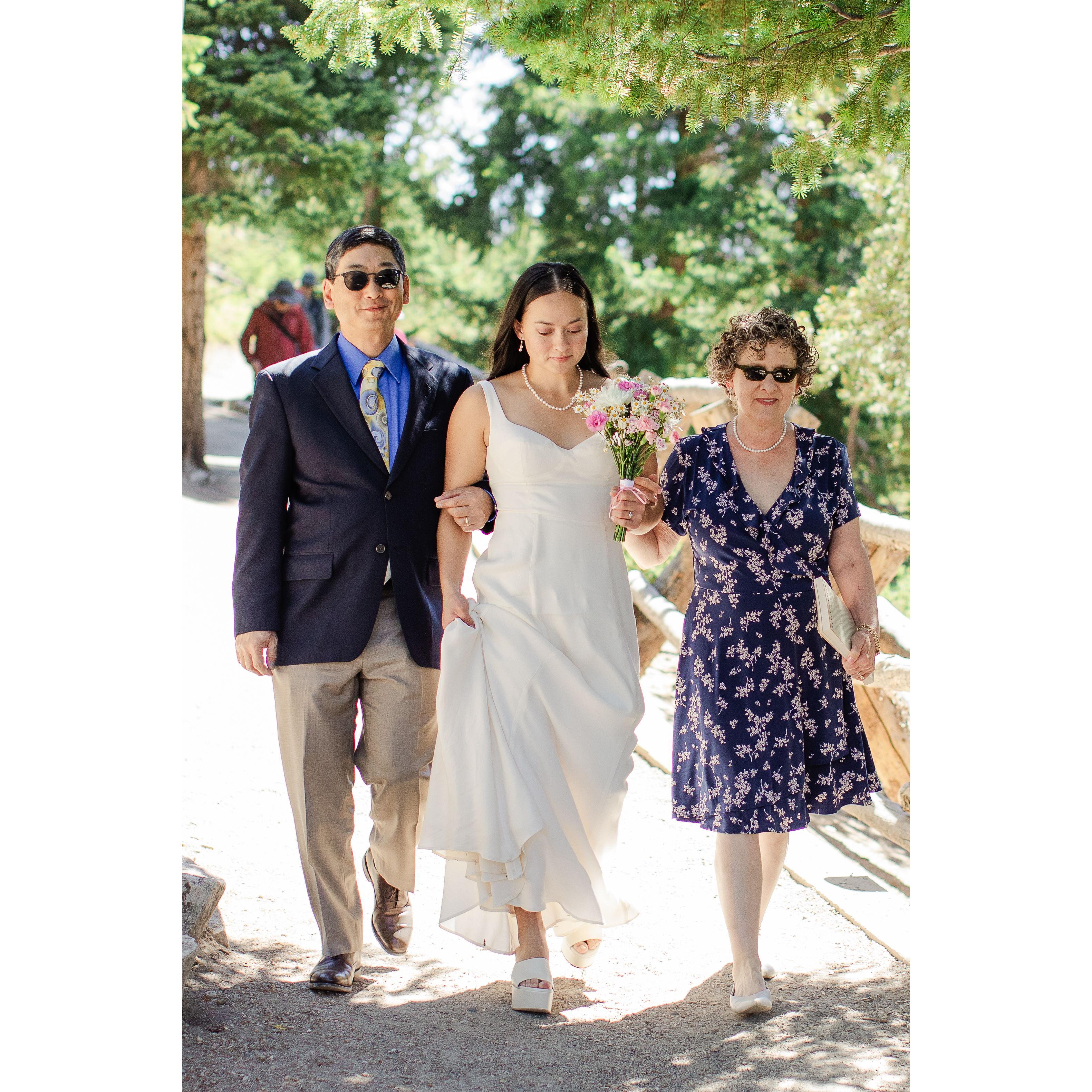 Nat's mother, Gina, and father, Stan walking her down the "aisle"