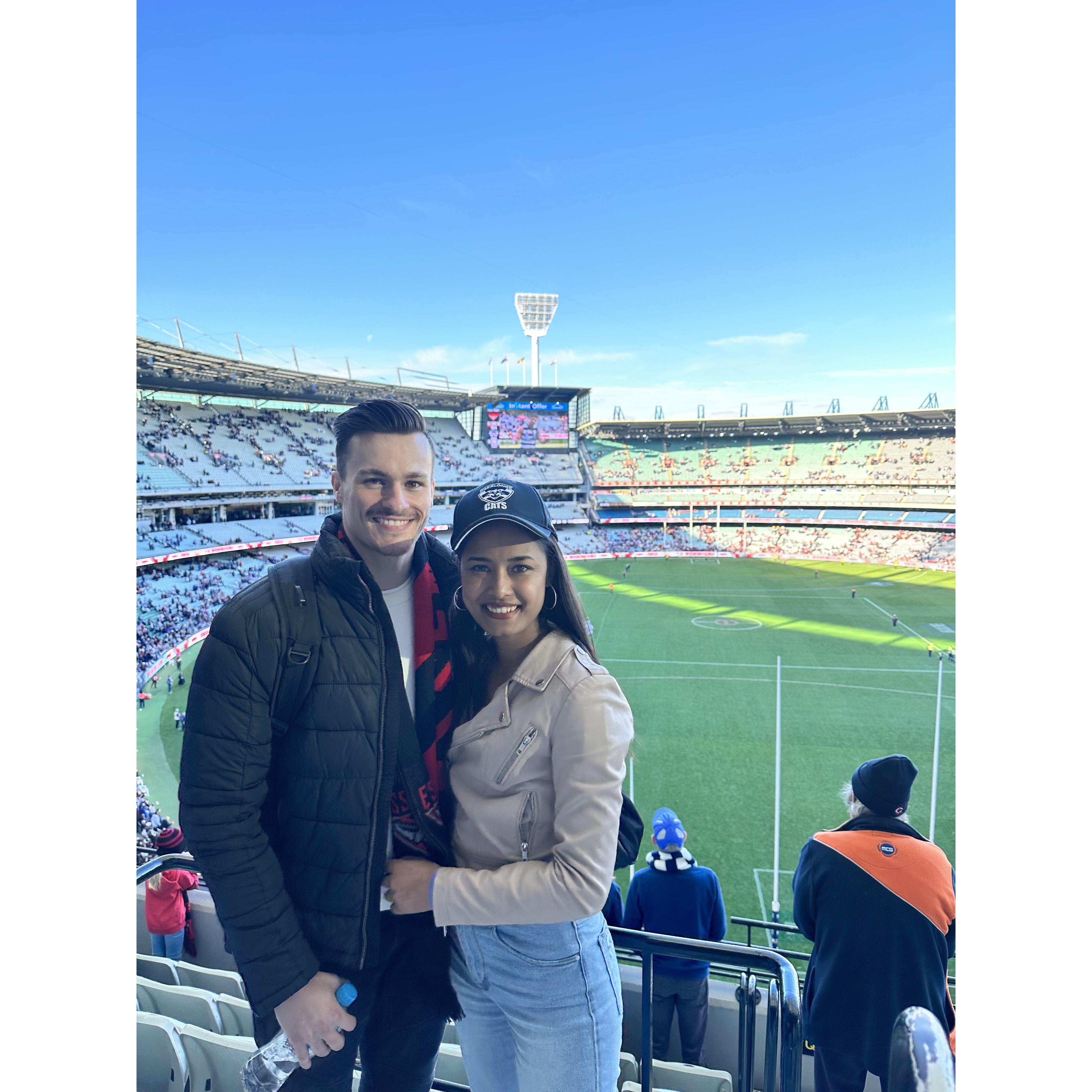 Our first live AFL game together, and Tyler gave it his best shot trying to convert Soni into an Essendon supporter—let's just say, it didn't quite work out!