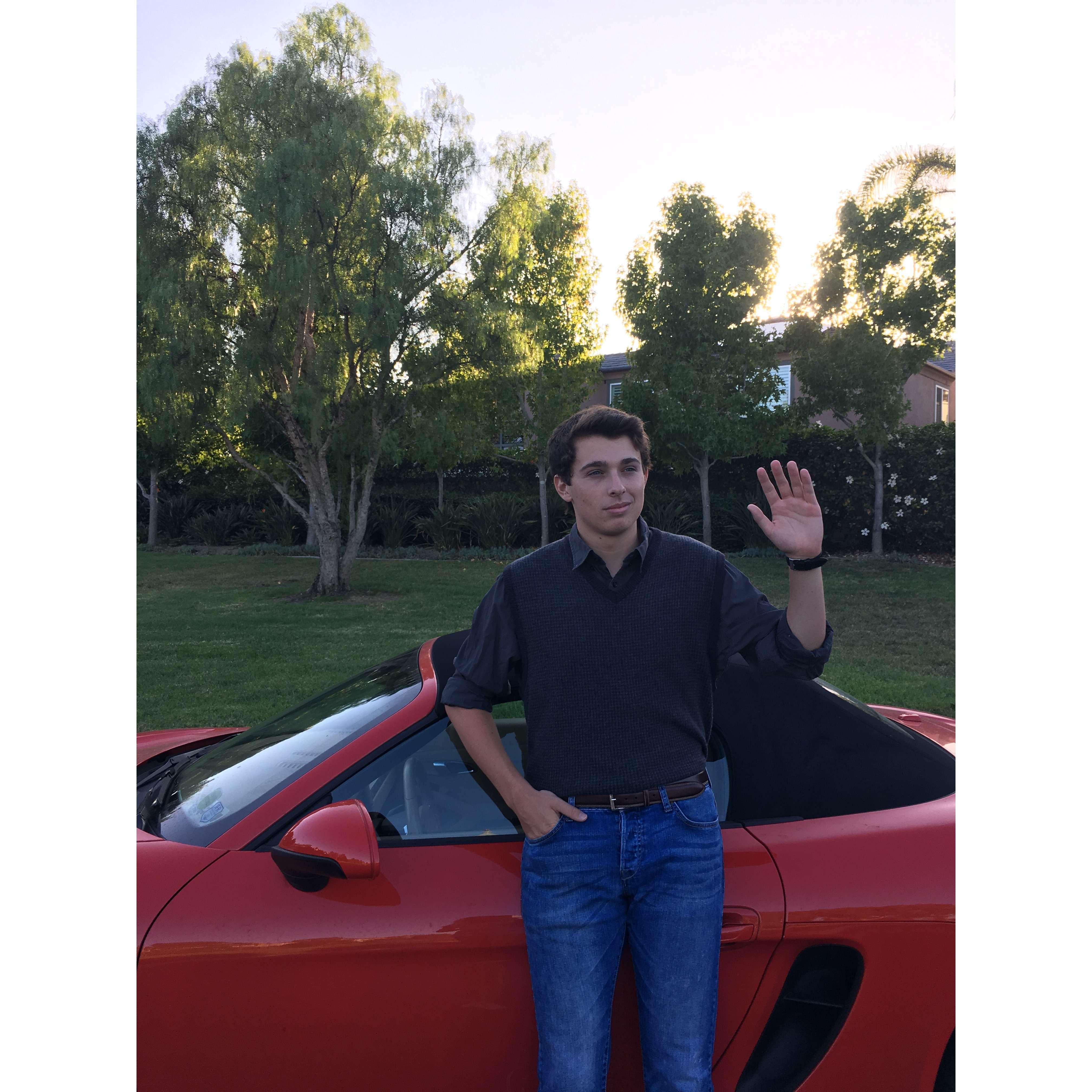 Jake saying goodbye to his iconic red Porsche before leaving for college, dressed as Jake from 16 Candles.