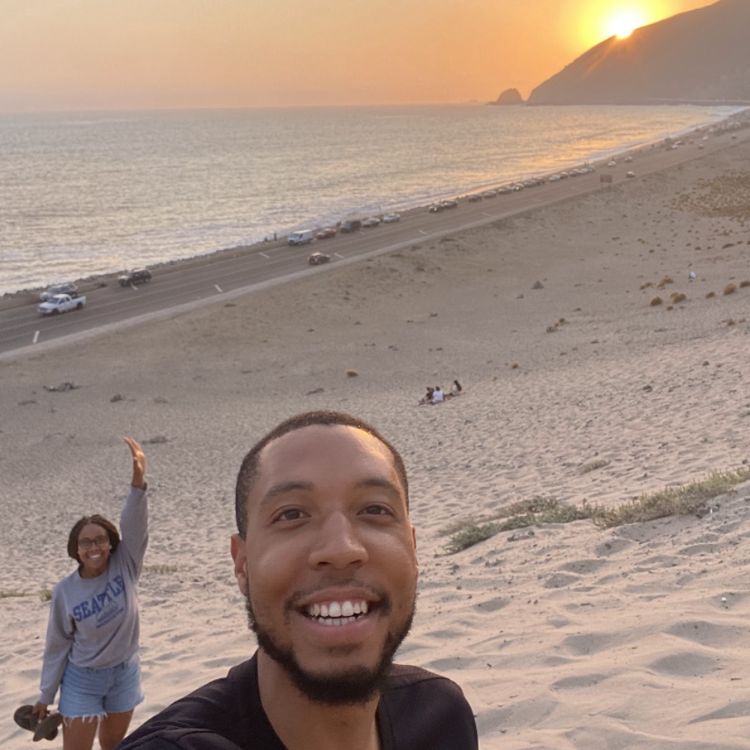 Hiking up a sand dune along Highway 1 in southern California.