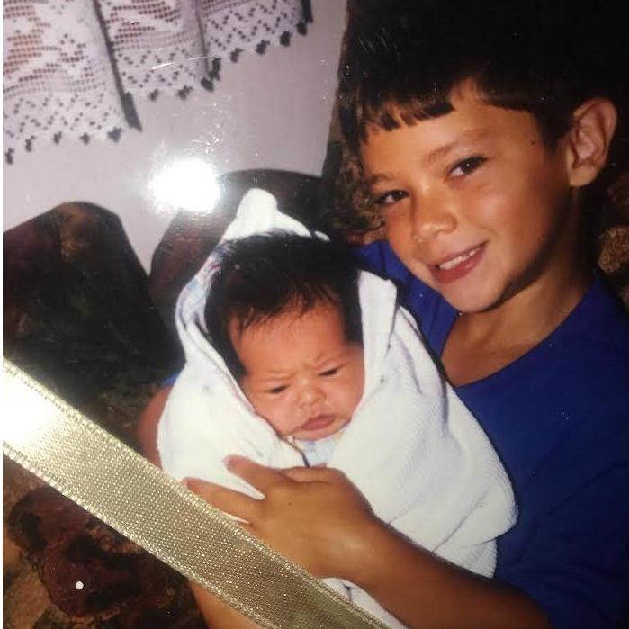 Brandon being held by his brother Josh
