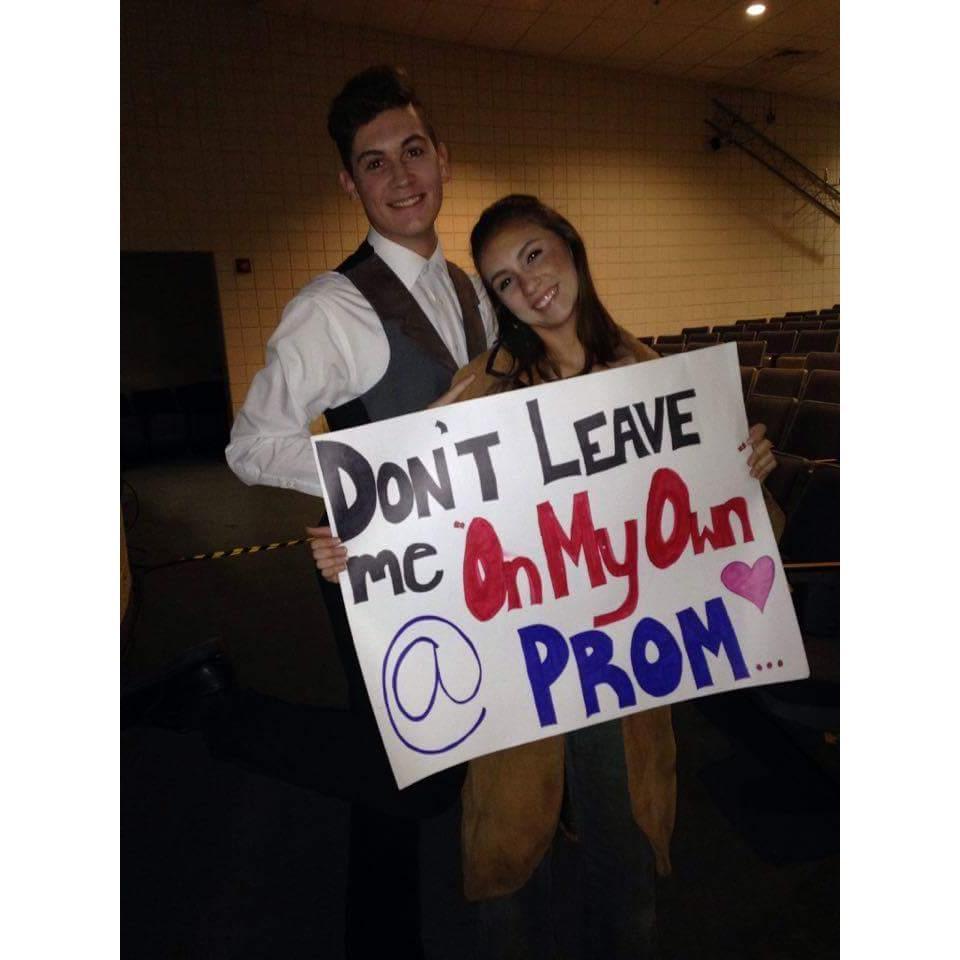 Lexy asked Jentry to go to senior prom by holding this sign up after closing Les Misérables.