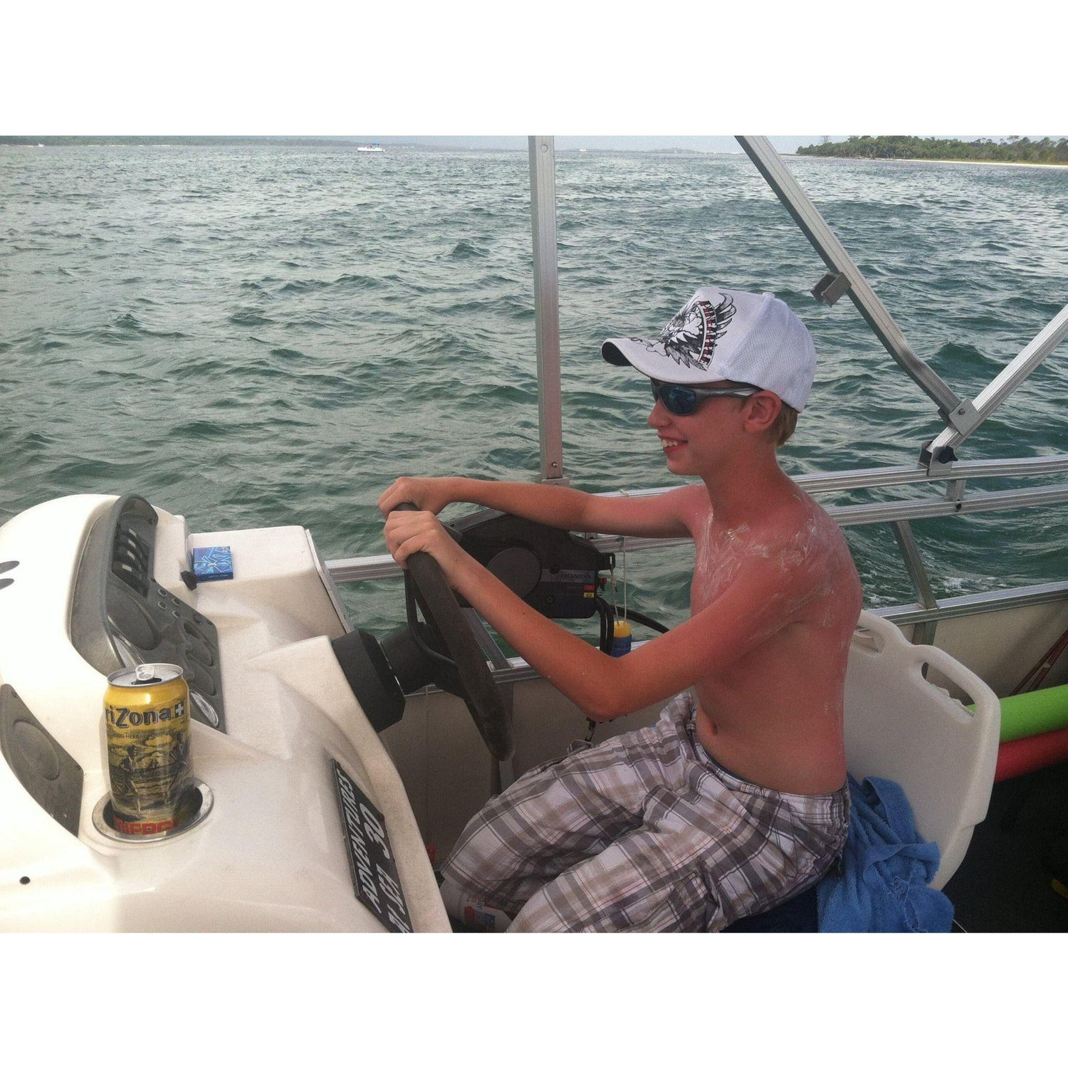 CJ driving a pontoon boat