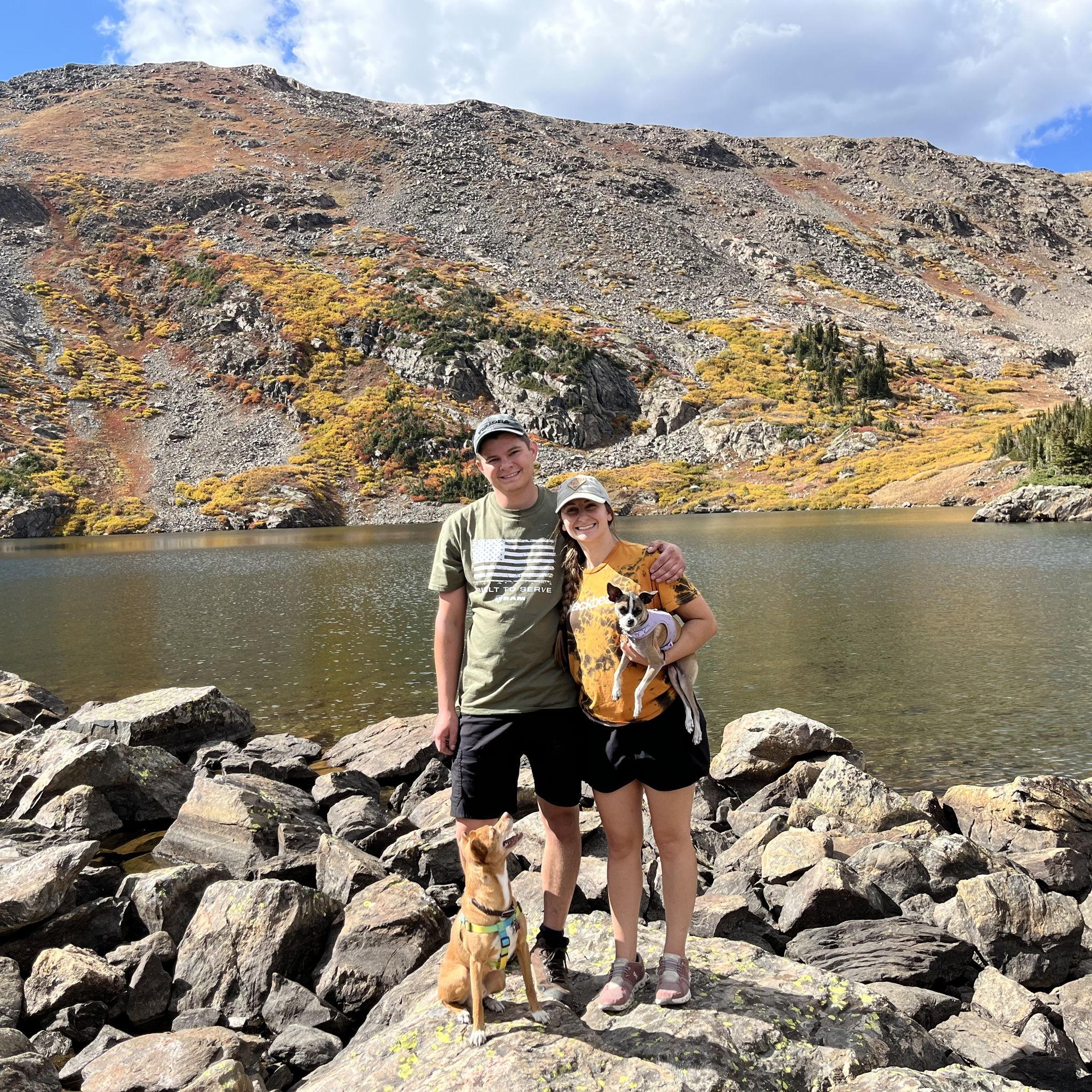 A "family" photo here includes their 2 dogs. Ollie (the one on the rock) and Mary Poppins (the one in Cassie's arm).
