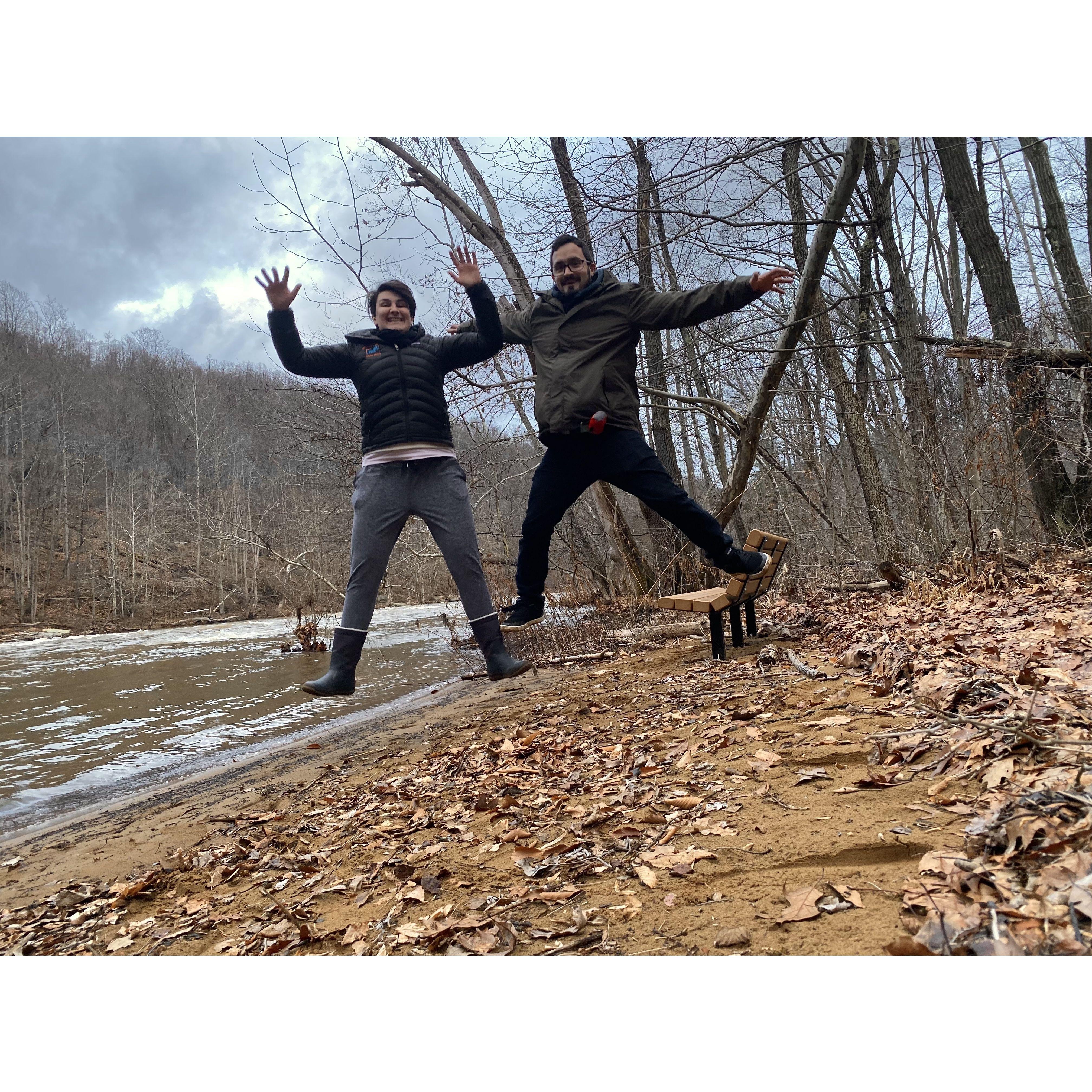 Jumping for joy riverside in Confluence, Pennsylvania, USA.
