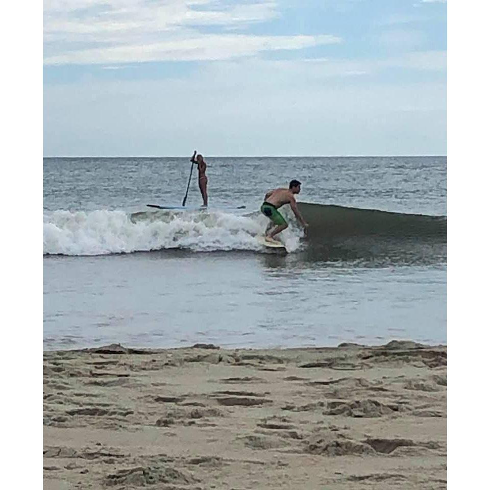 Anthony attempts some tiny waves in Corolla, North Carolina, while Stacey paddleboards in Lake Atlantic.