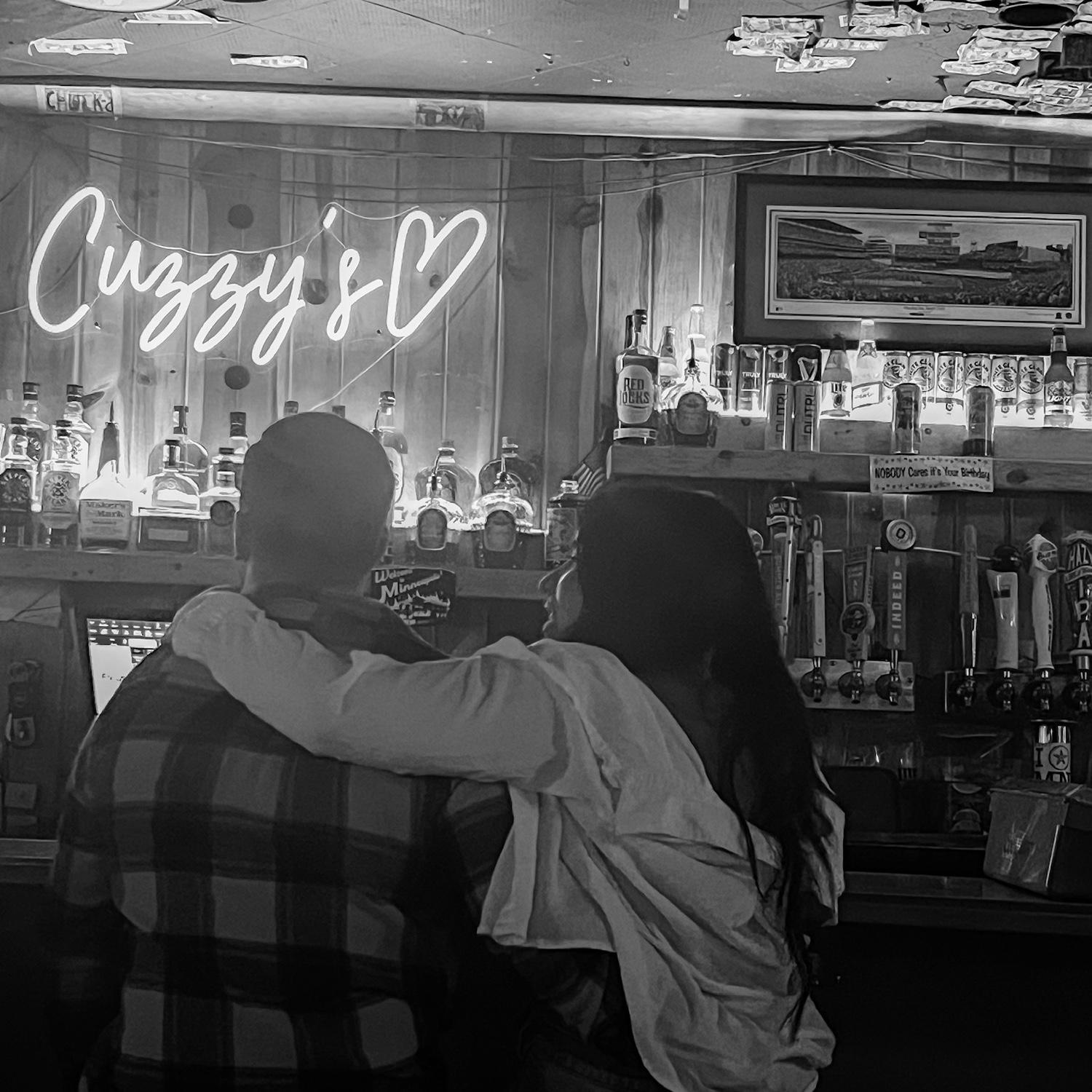 The first picture we ever had together on our second date. 

A random girl took this without us knowing & was adamant on sending it to us. Years later, we are SO happy to have this memory captured!