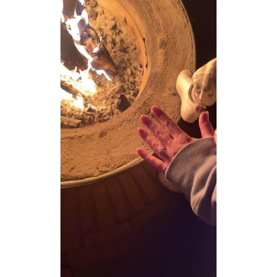 Moments after Travis popped the question sitting around the campfire