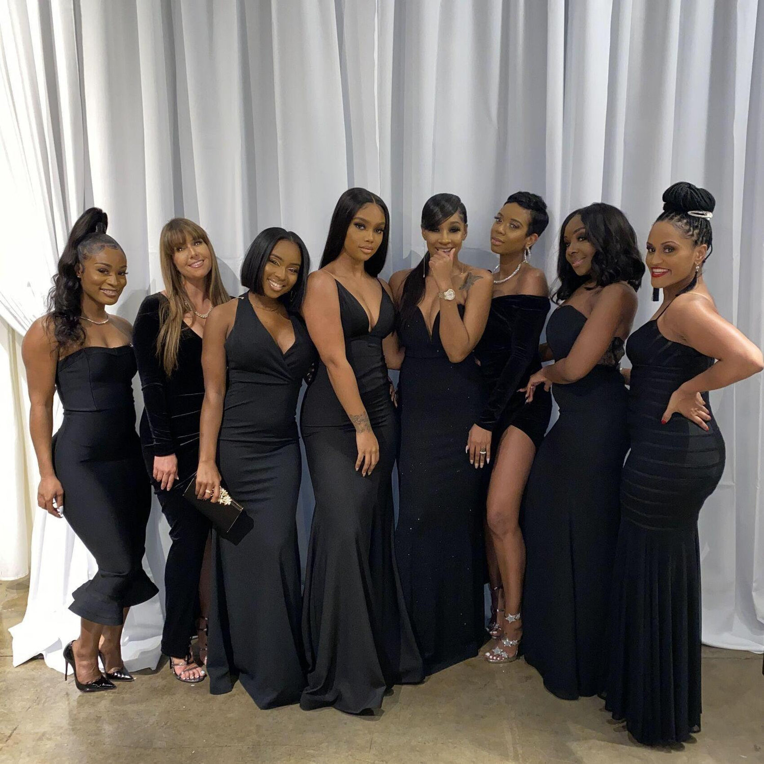 For ladies, long gowns, elevated cocktail dresses, or formal jumpsuits in black.