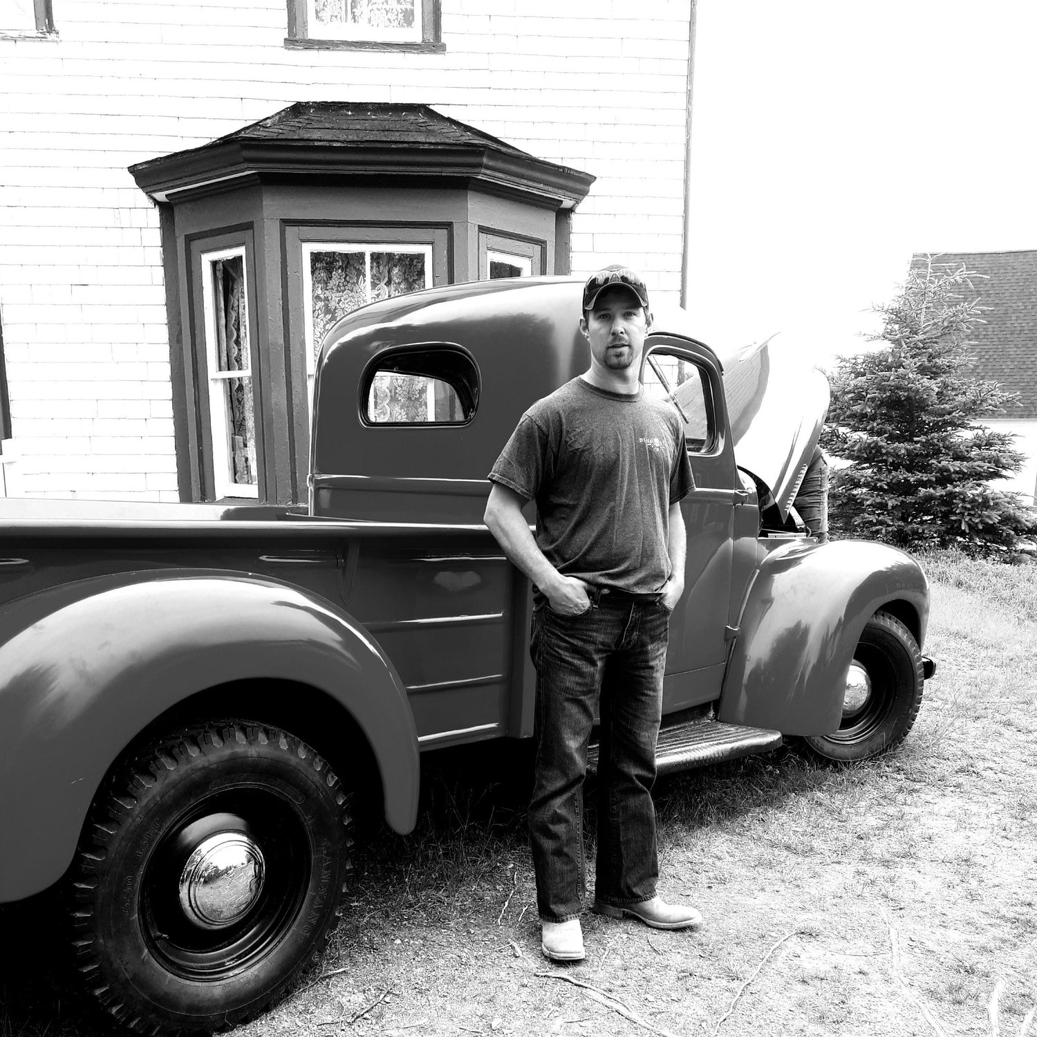 Clayton in front of the Heritage house