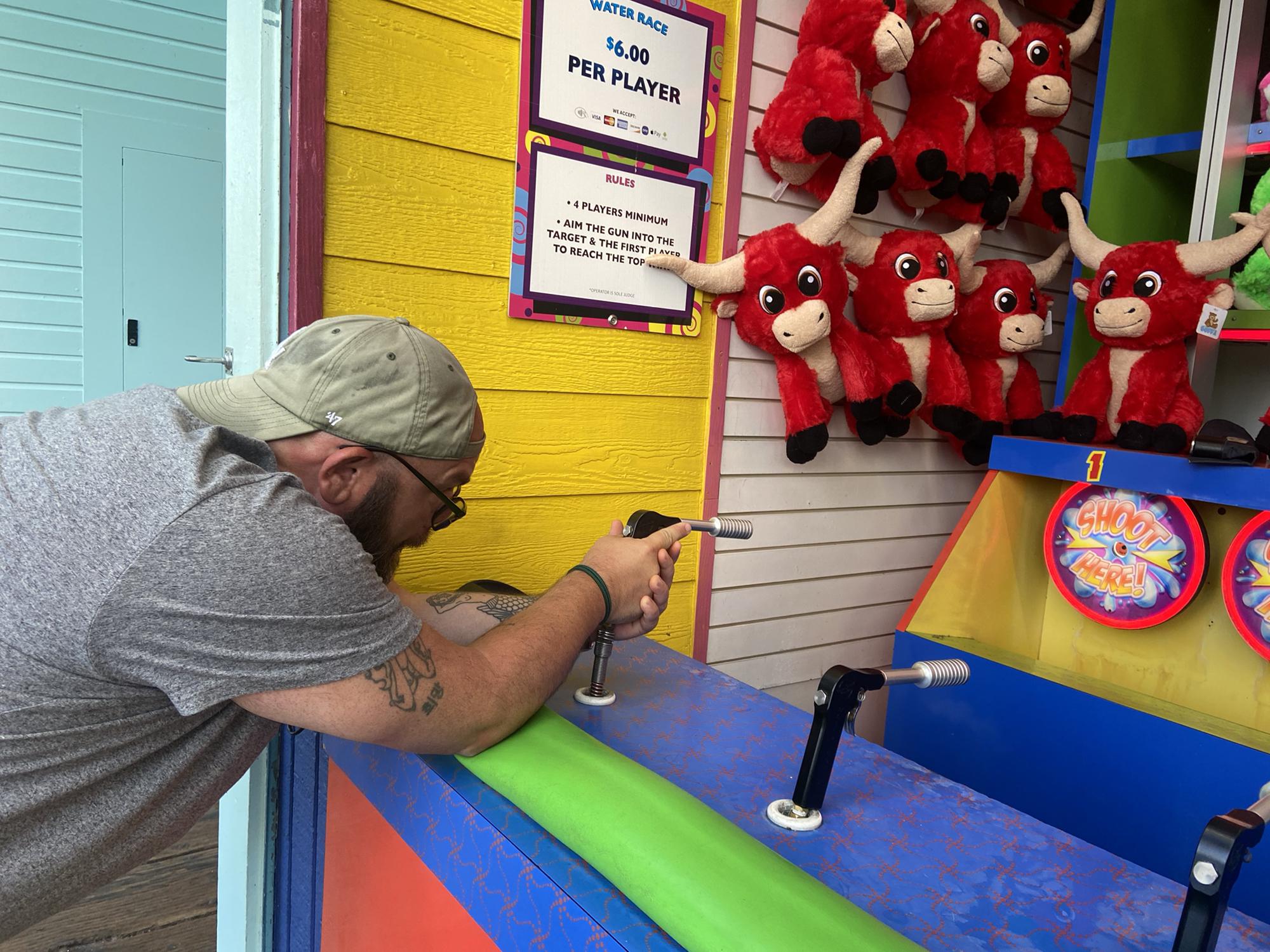 Ed trying to win a prize for Meg in 2021 at Santa Monica Pier