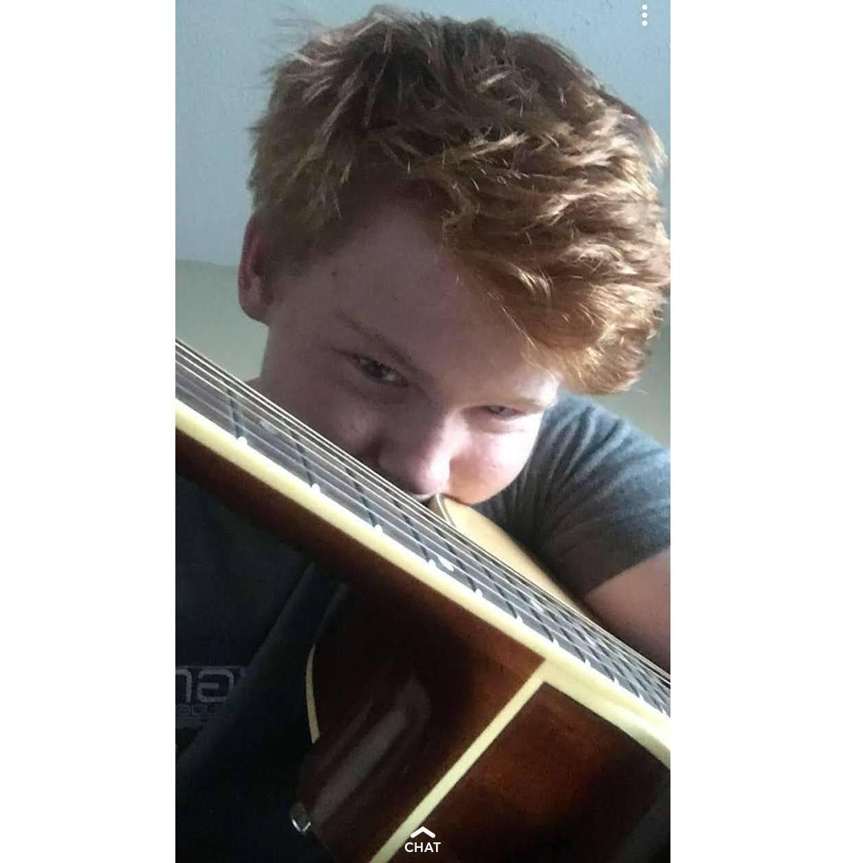 Michael playing guitar over facetime for Desiree