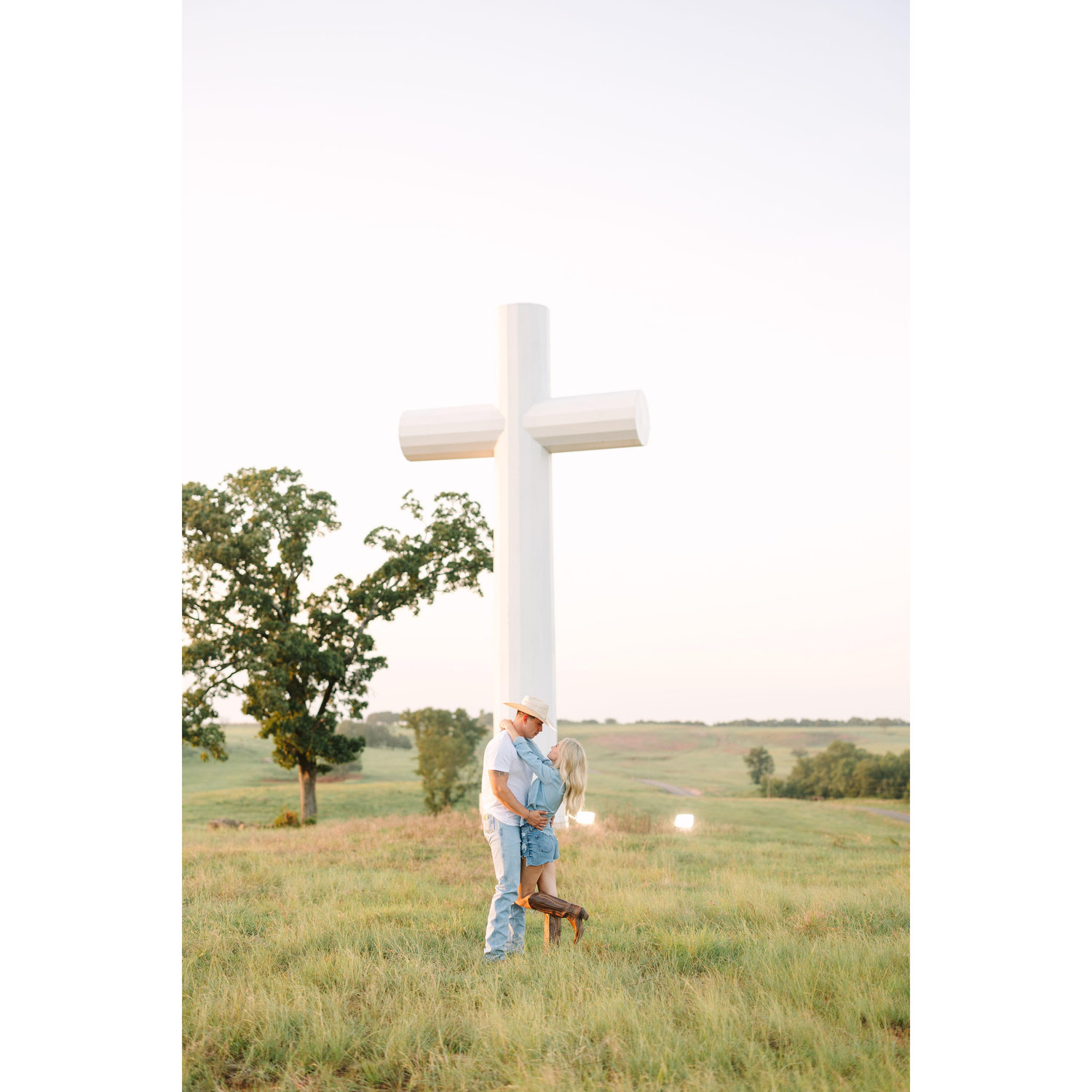 engagement picture next to the cross on the Orr Family Ranch