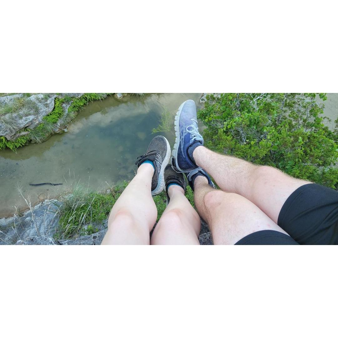 Sitting together on a cliff drop watching the horizon