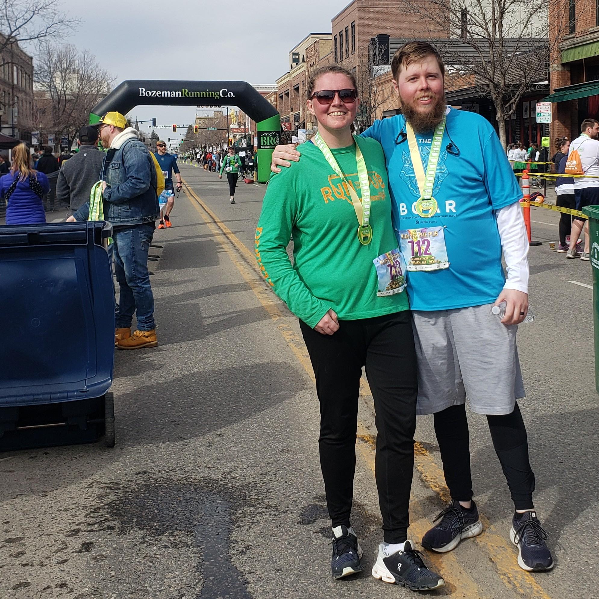 at the finish line of the Run to the Pub 10k, a longstanding goal of ours!