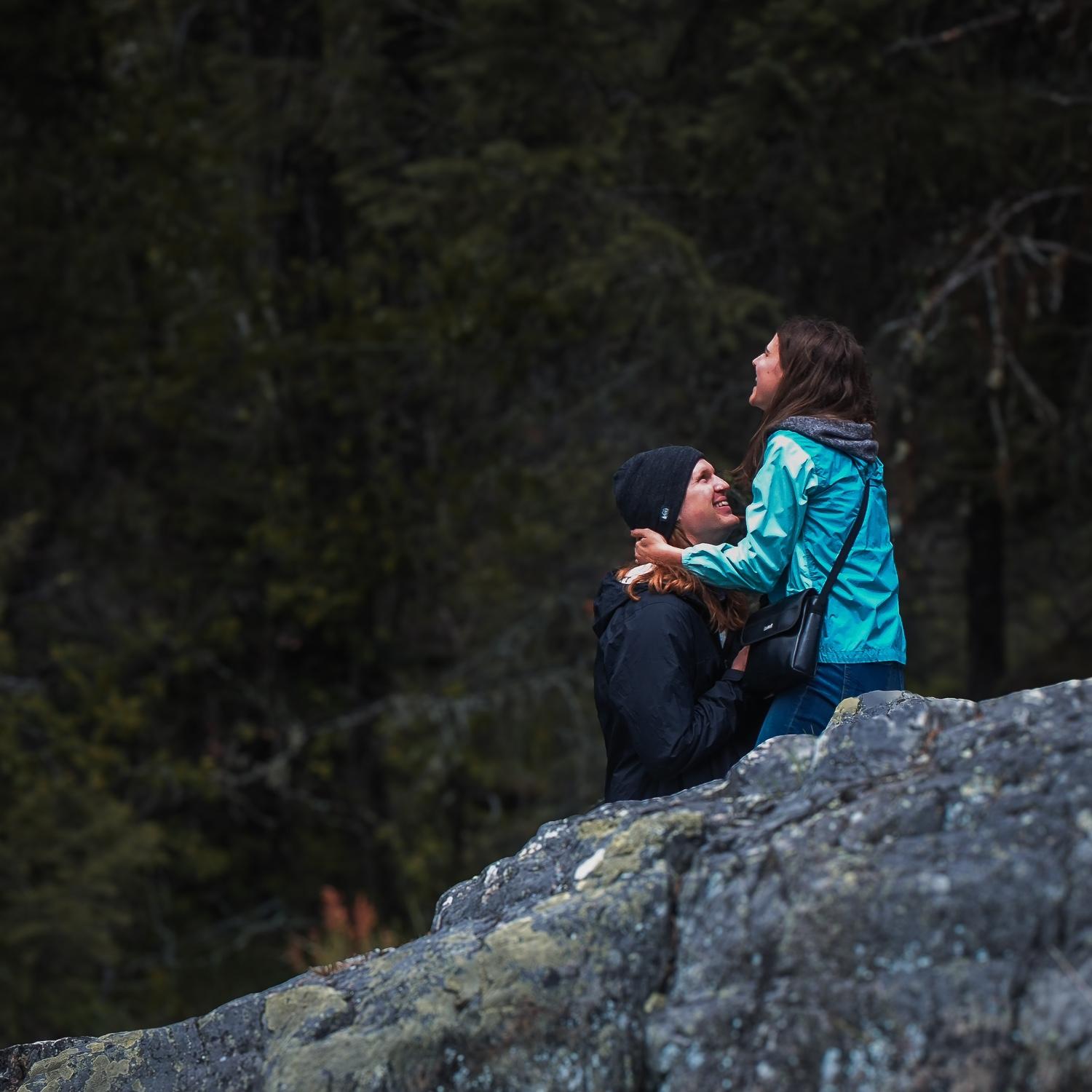 Proposal at Two Sisters Rock on the Swan River! Our friend from church, Ben Erickson, was kind enough to hide across the river with his camera and catch photos of the moment. Thank you Ben!!!