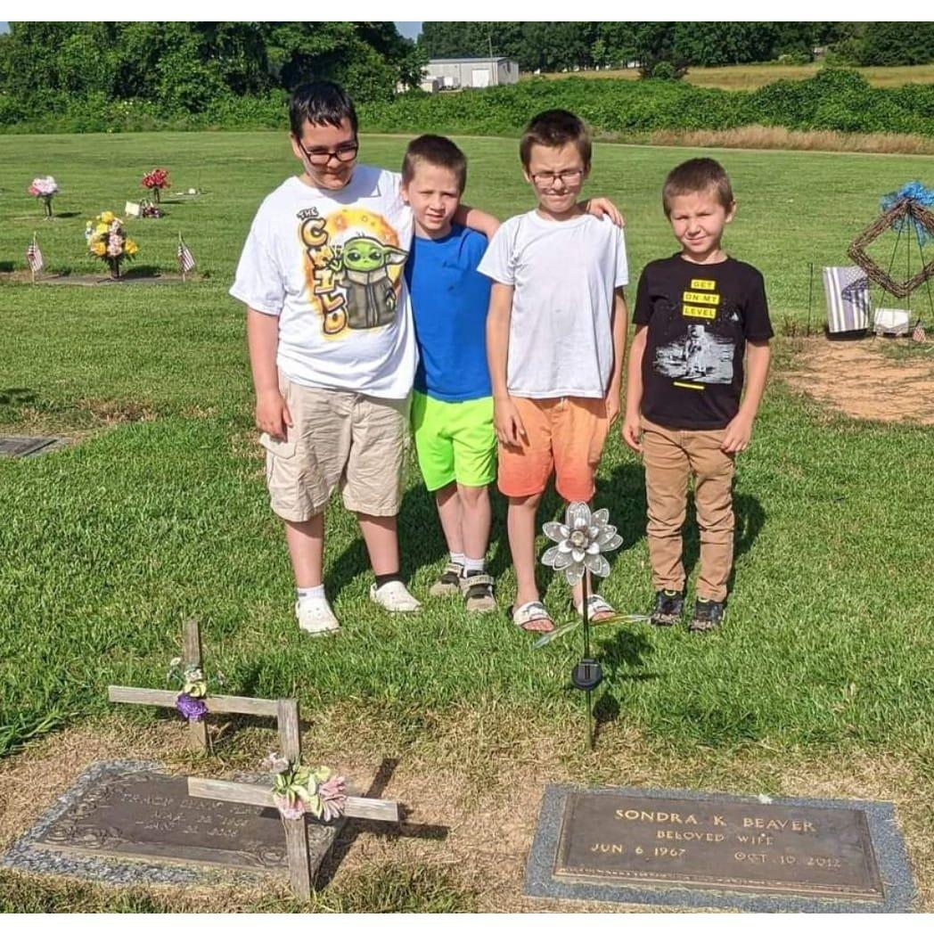 Cousins together at Christian's aunt and mom's graves in Mississippi