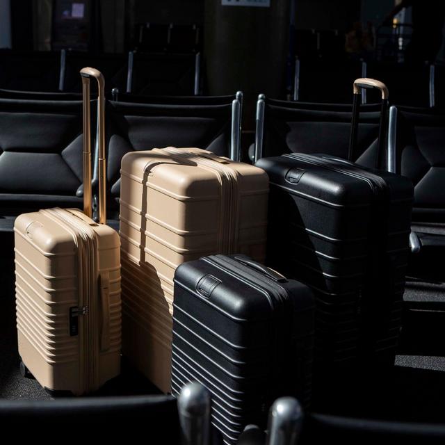 the 29" large check-in roller in black and check roller bag