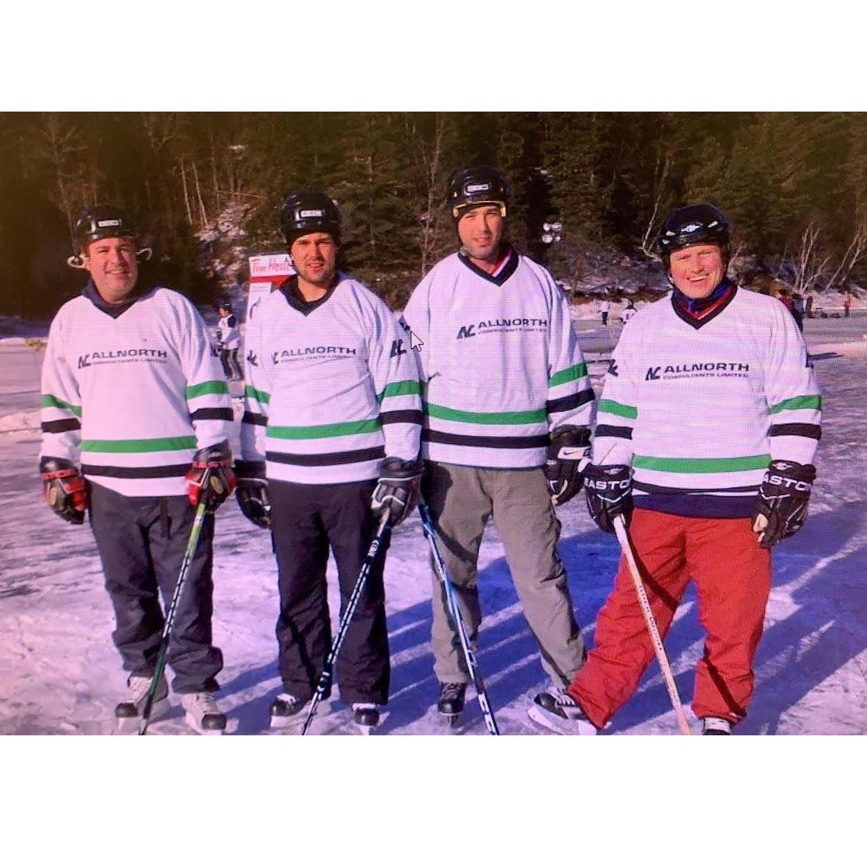 Greg, Colin, Andy, and John with their skates laced up.