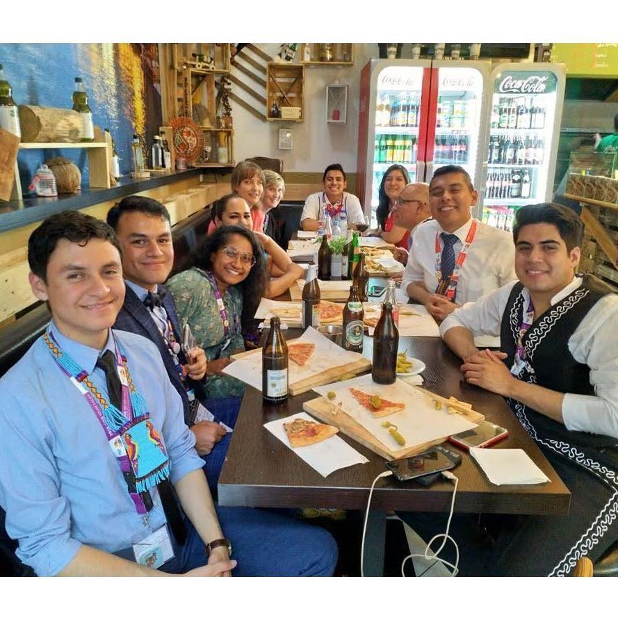 Eating pizza with friends at international assembly