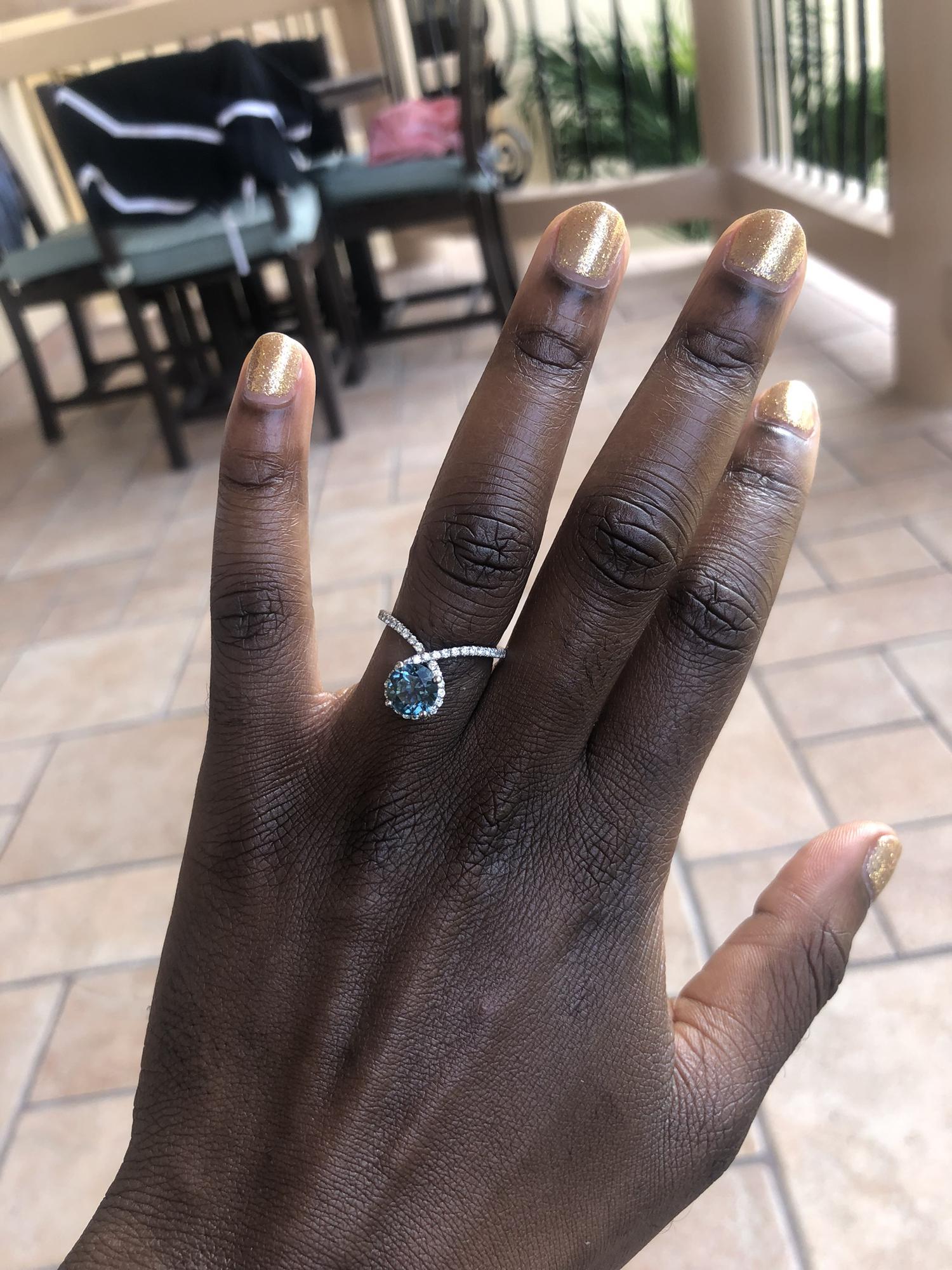 The morning  after I said yes!!  It's a Montana Sapphire. Sapphire for my birthstone and Montana mined because sustainability and Montana sapphires are my favorite hue of blue which is turquoise.