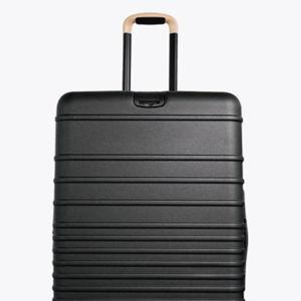 The Large Check-In Roller in Black with Beige Handle