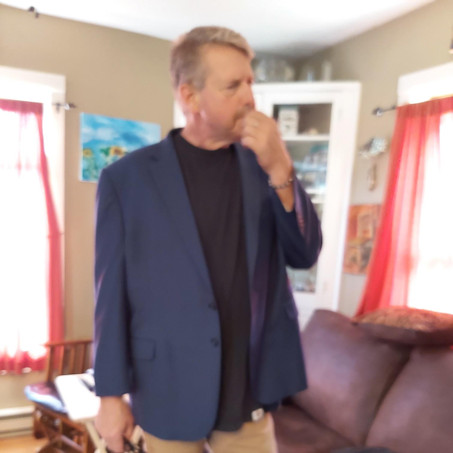 Mike trying on a suit jacket for the weding. Sleeves too short!