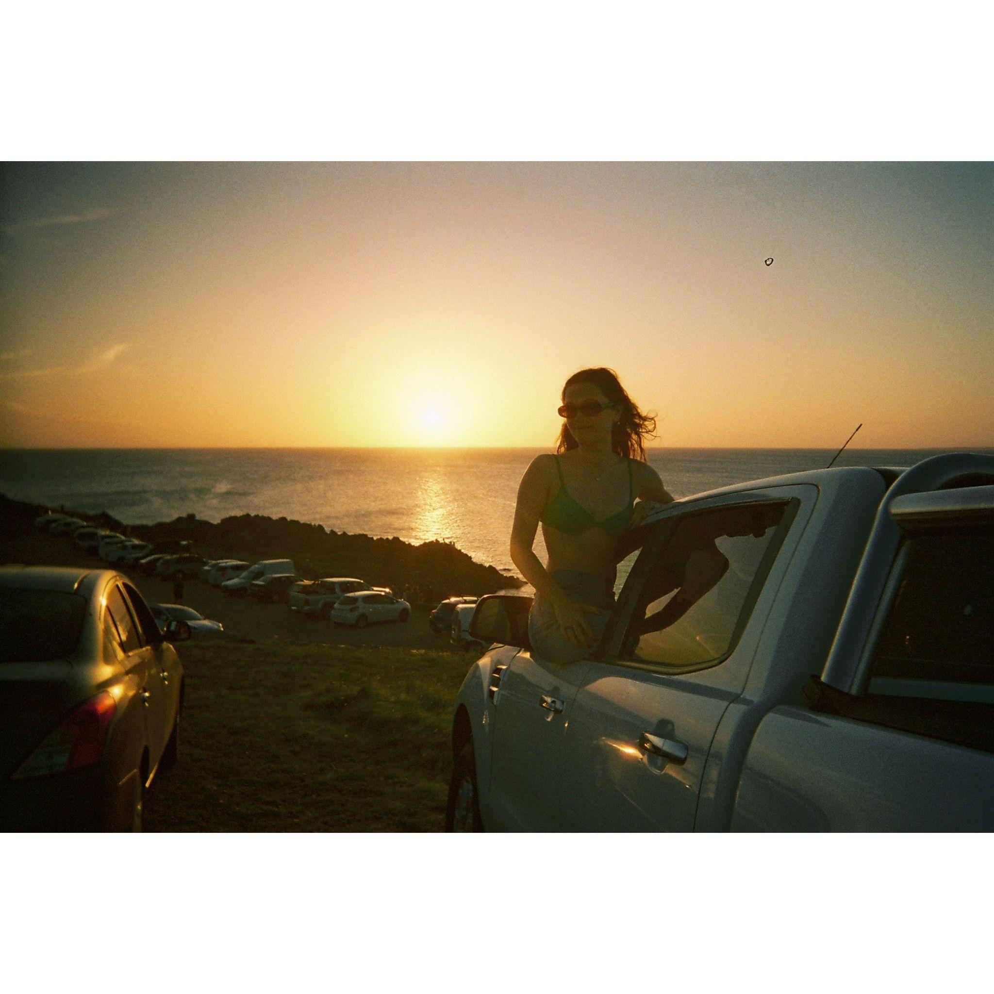 A breathtaking summer sunset in Punta Ballena, Uruguay, viewed from the window of Manu's Ford Ranger