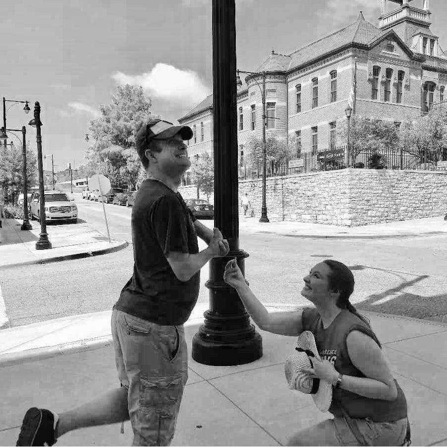 Matt and Katie didn't take any pictures of their "real" proposal where it was just the two of them. HOWEVER, one week earlier during a vacation this was a required scavenger hunt photo in Kansas City!