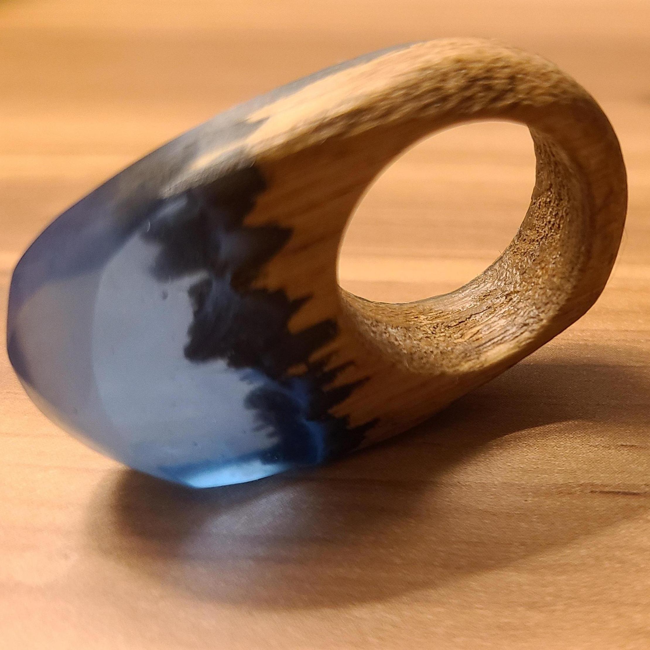 Hanse handmade a beautiful resin and wood ring to propose with, featuring Amanda's favorite color (blue) and landscape (snowy mountains). Hard to tell the details in photos, but it's stunning!