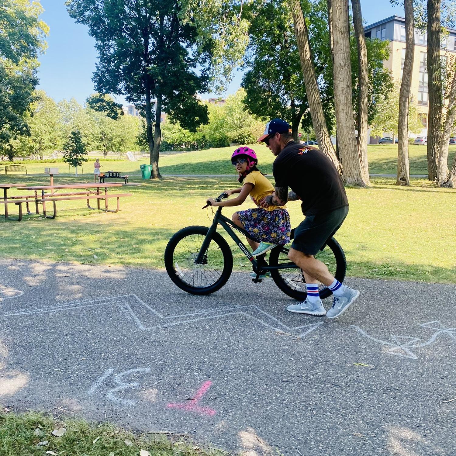 Casey teaching Zainab how to ride a bike!