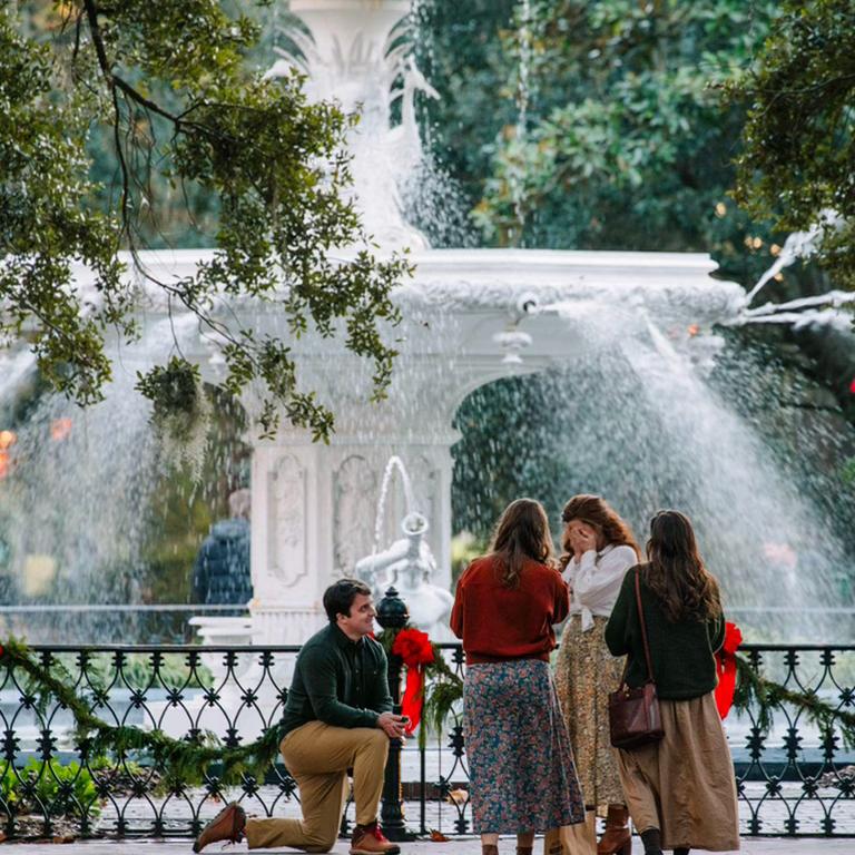 Surprise engagement in Savannah in Forsyth Park