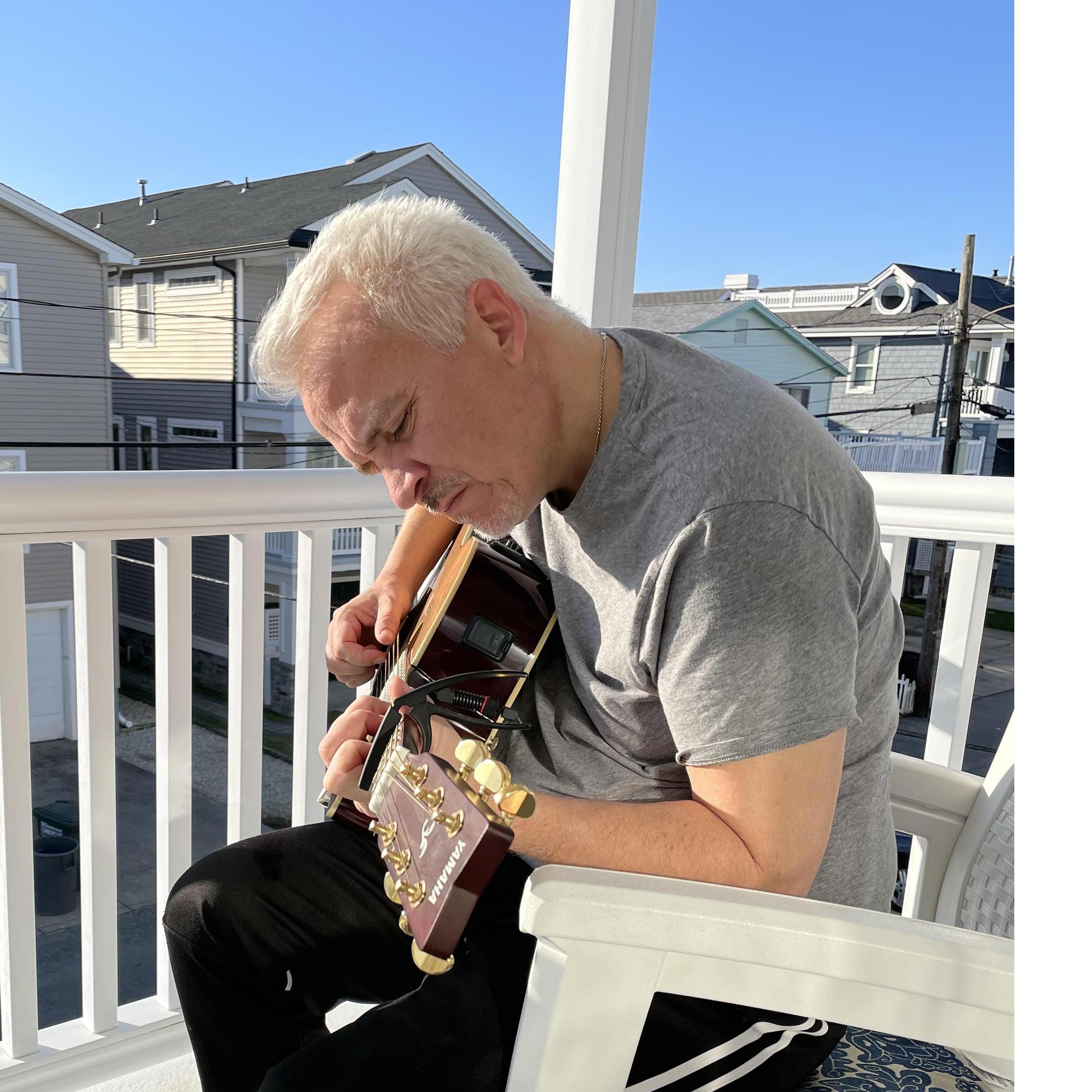 Strumming away. One of his favorite things to do in is favorite place.