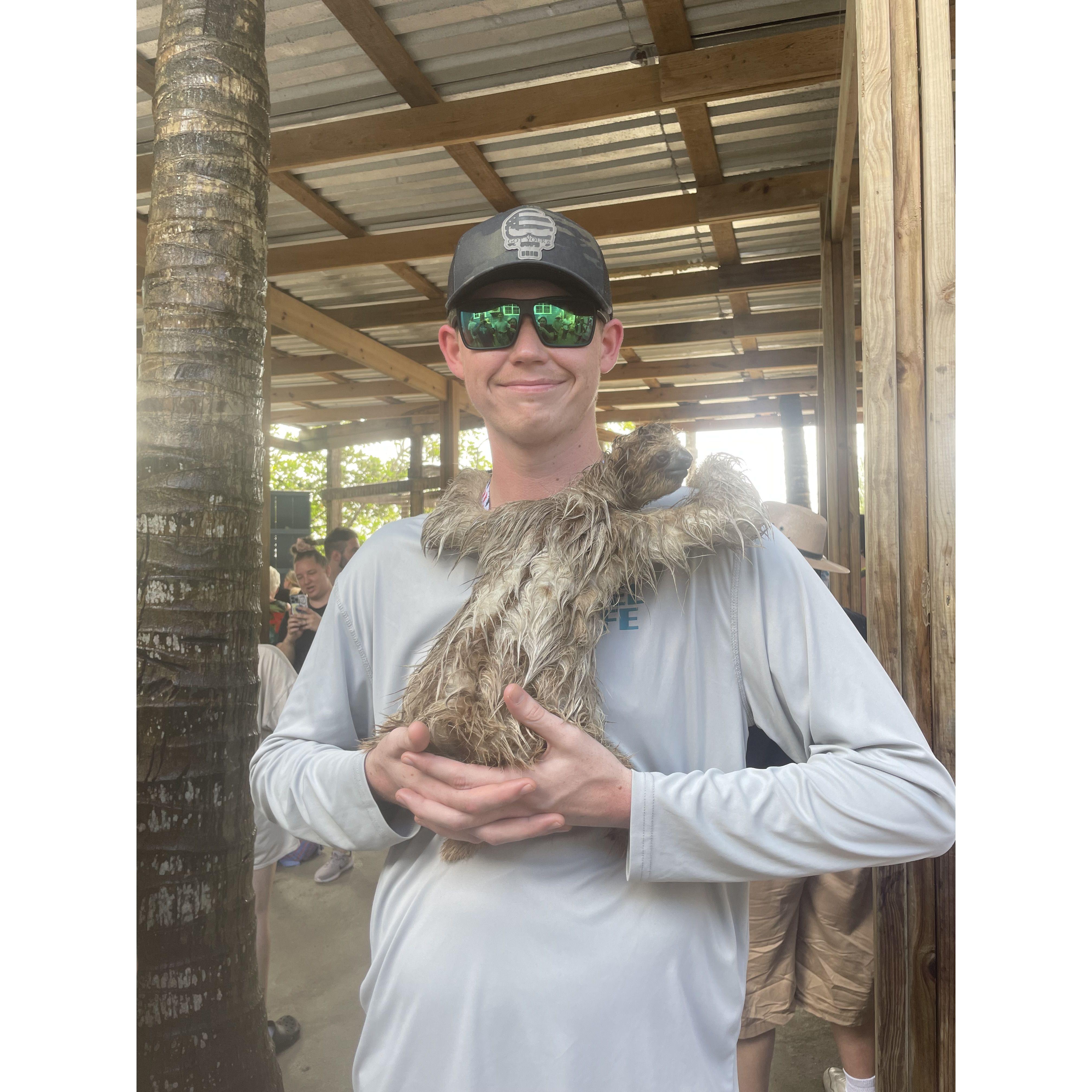 Ethan taking a picture with a sloth on our excursion in Roatan