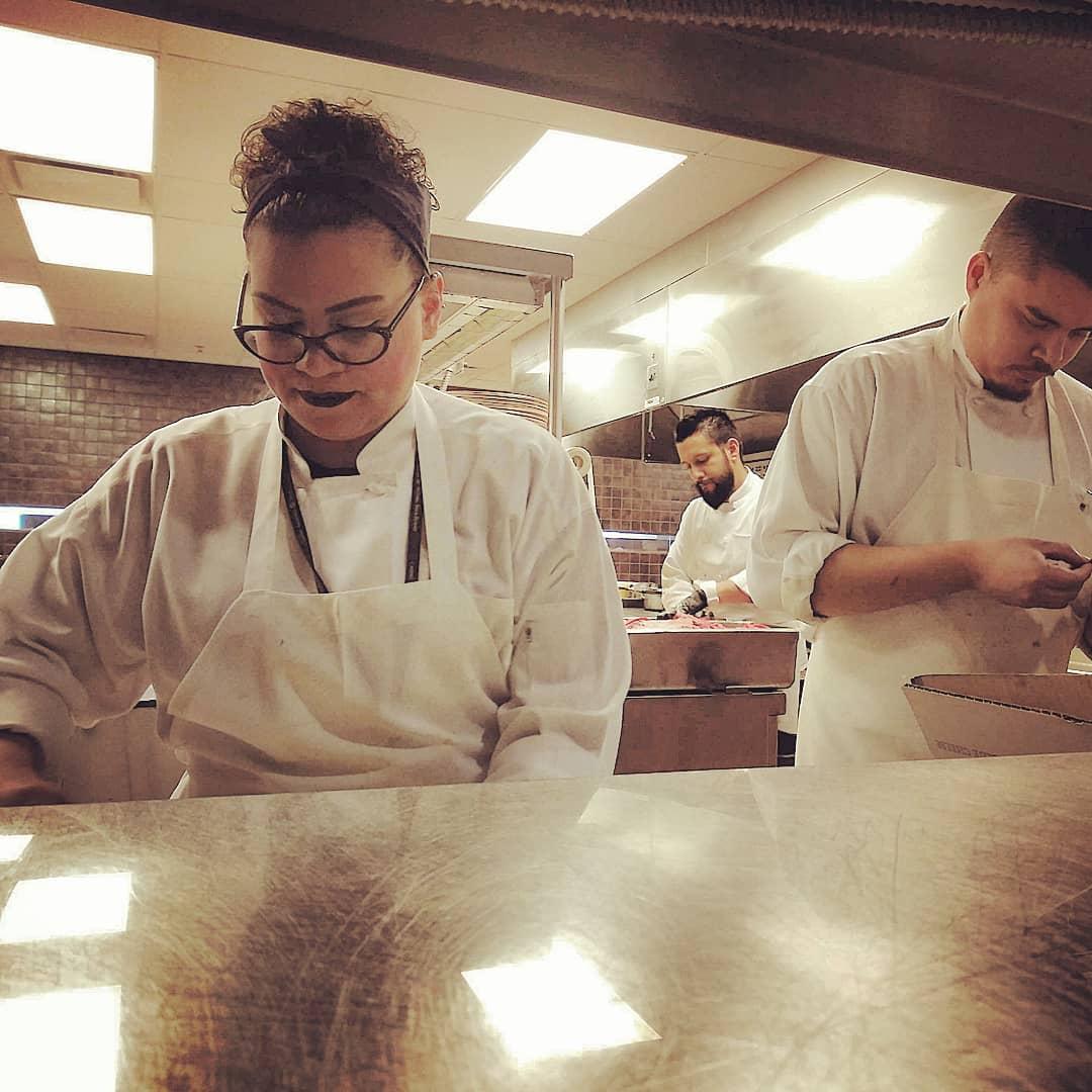 Zach helping Monique at work