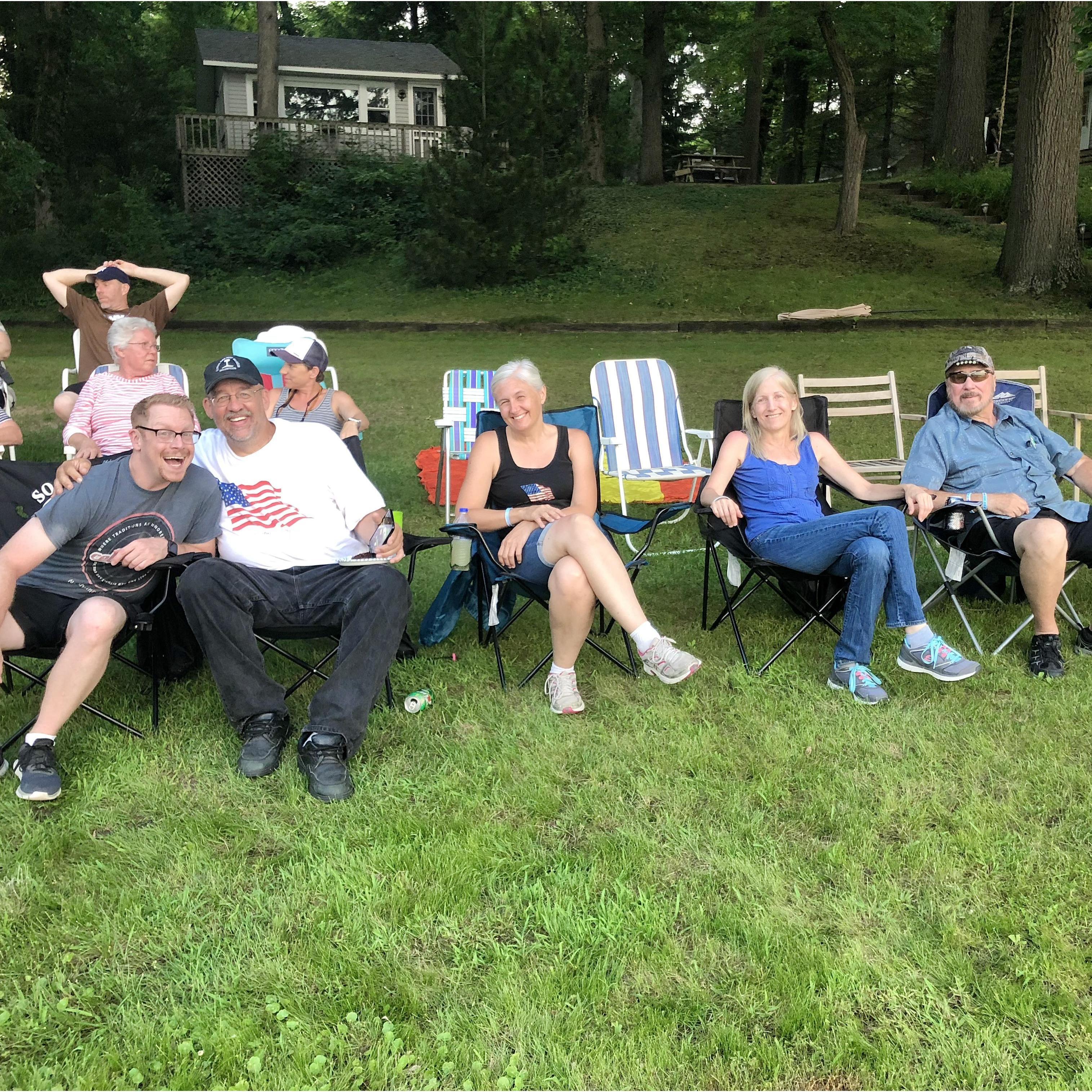 Matt, Uncle Ray, Aunt Julie, Robin, and Tom sit patiently as best family friends Terry and his son Brandon set up their annual Fourth of July fireworks display on the lawn of their home in Michigan.