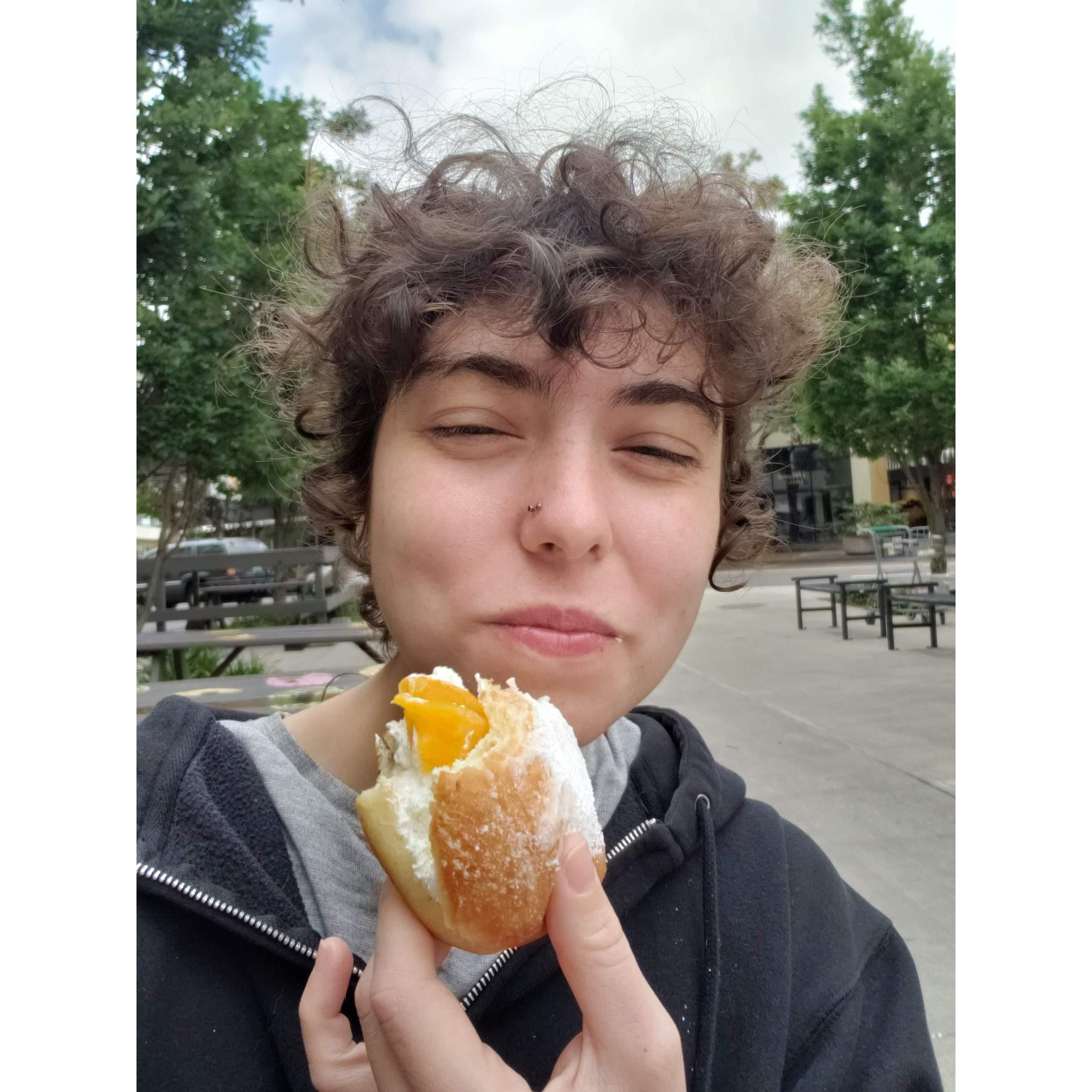 Rex enjoying their first vegan donut on the west coast