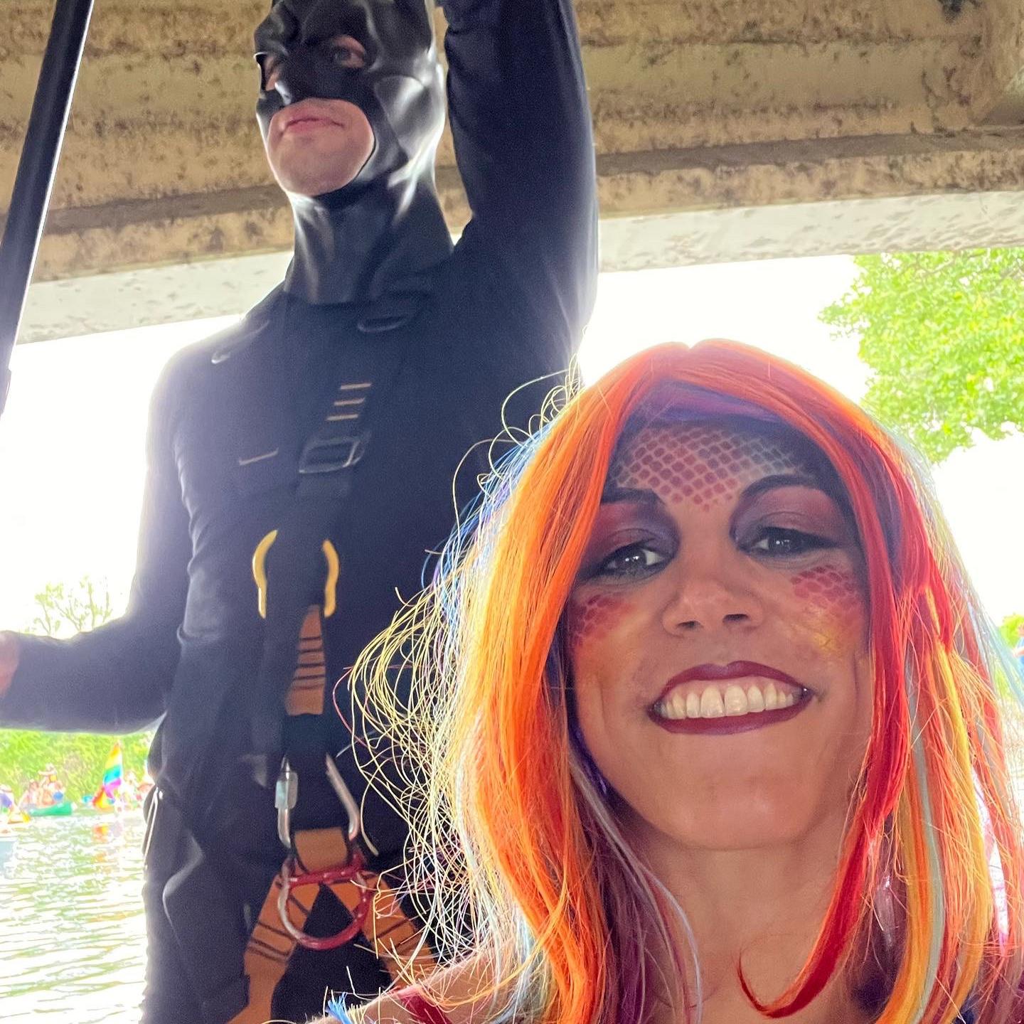 Batman and a mermaid, paddling down the Yahara river as part of the Fool’s Flotilla