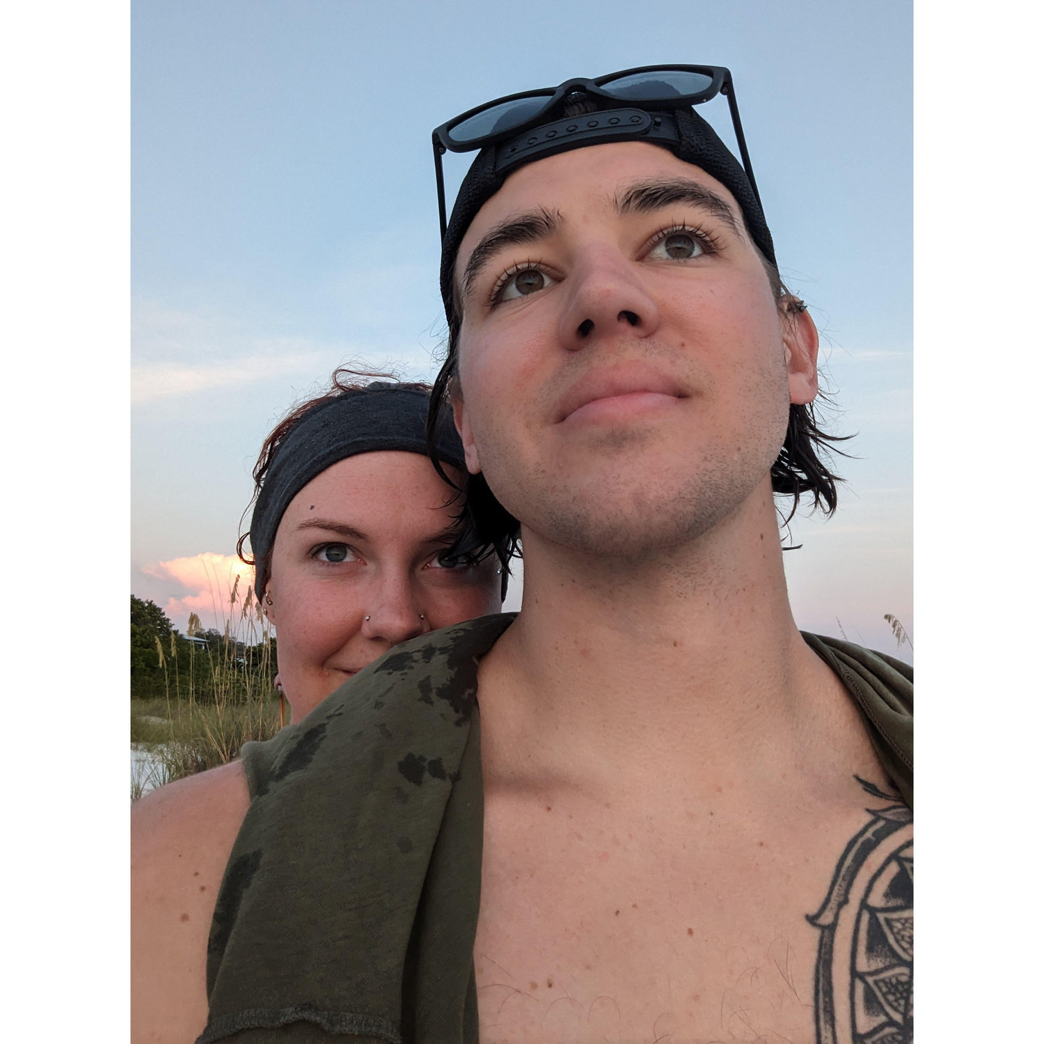 Our faces as we watch the sunset off a beach in Florida in 2023