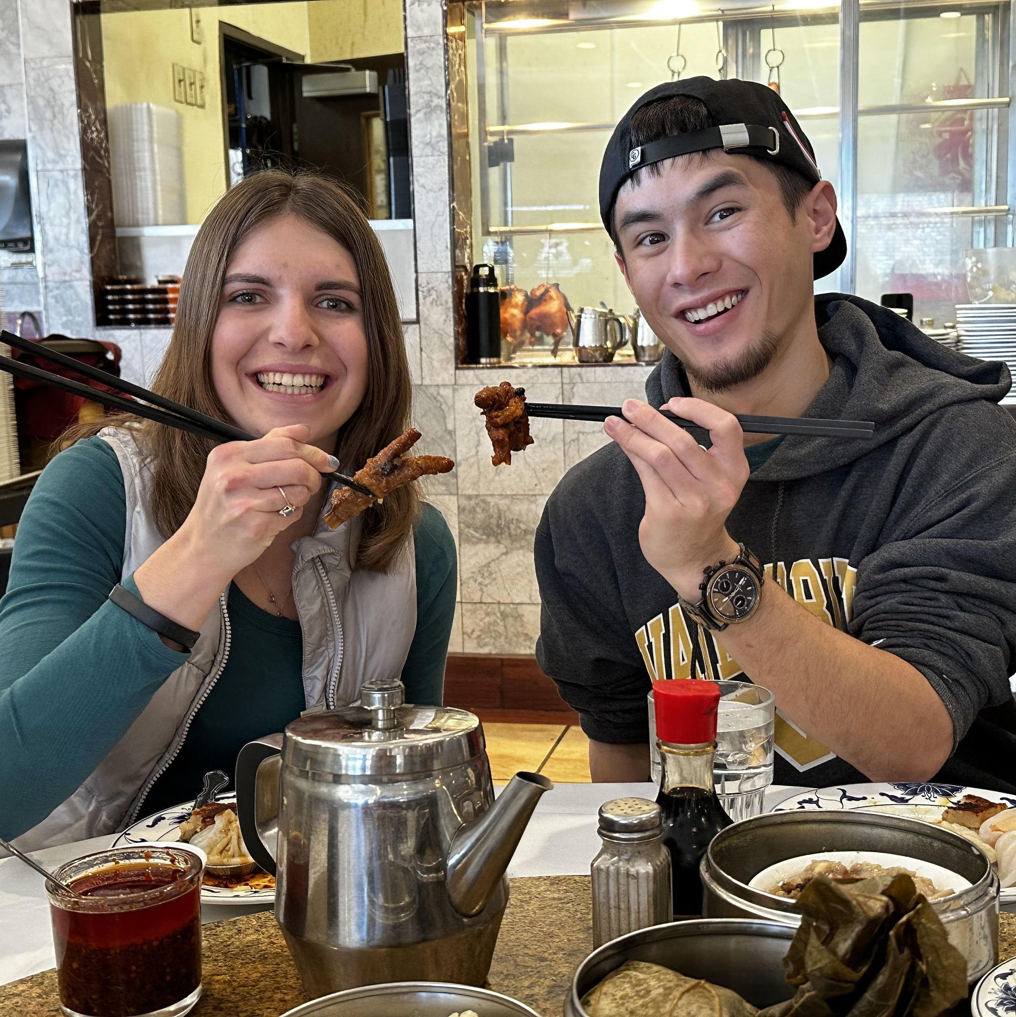 Bree trying chicken feet for the first time at dim sum when she first met Max's family