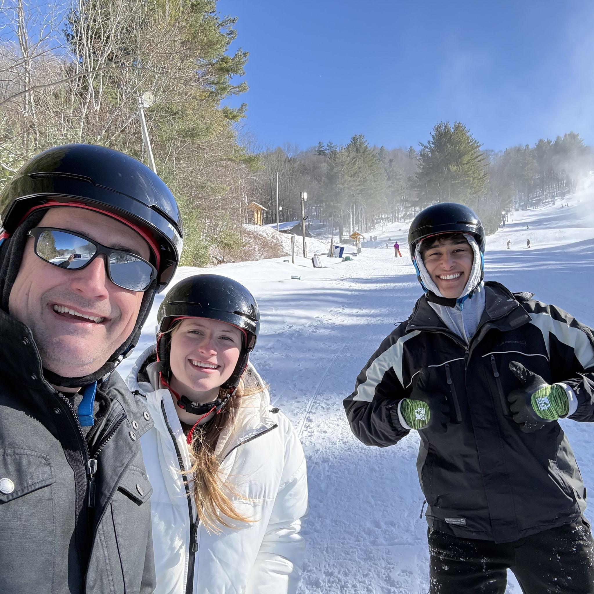The groom snowboarding with two of his in-laws