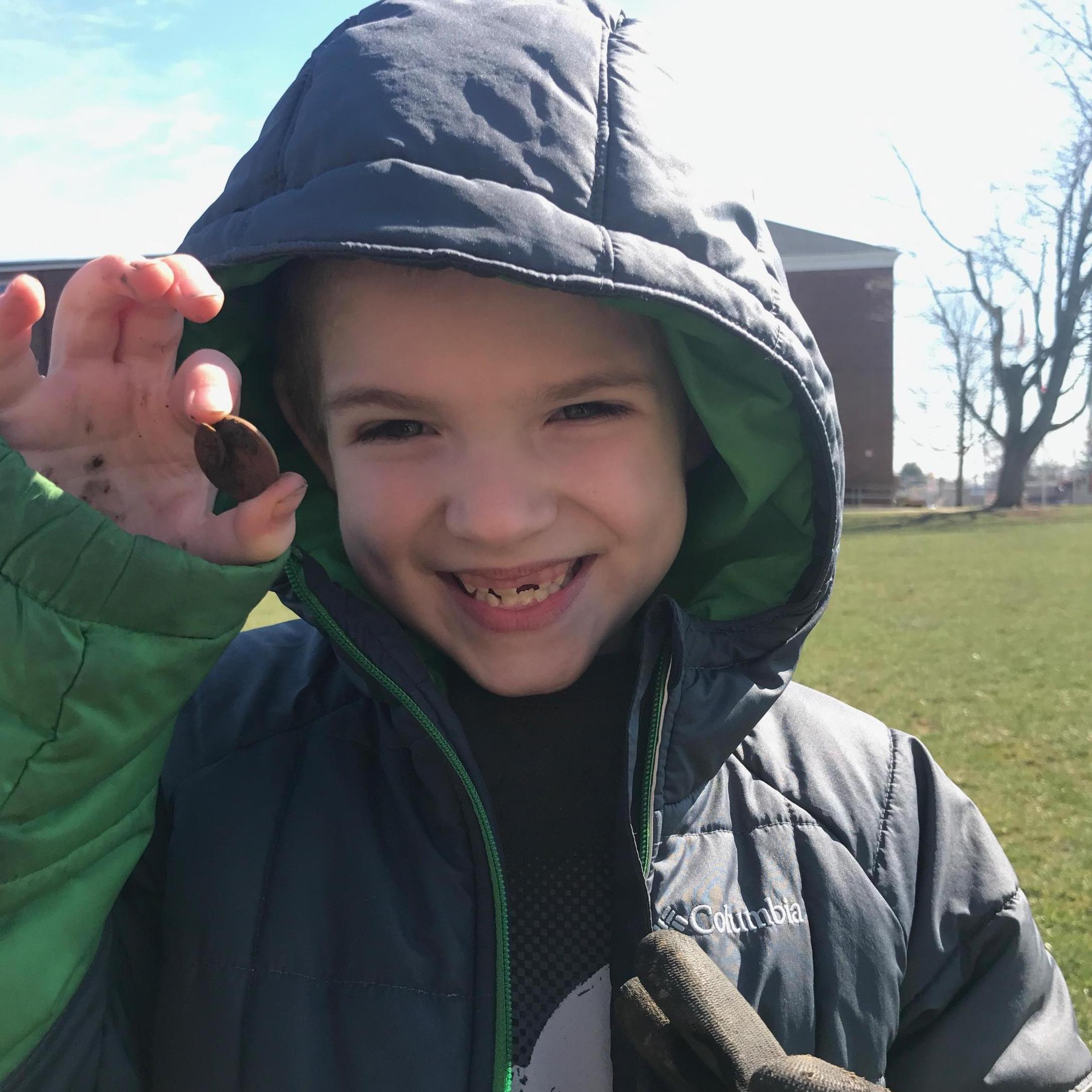 Finding his first coin metal detecting with daddy.