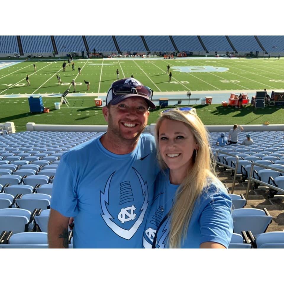 Shared passion for UNC football! Ok...ok, he converted her!