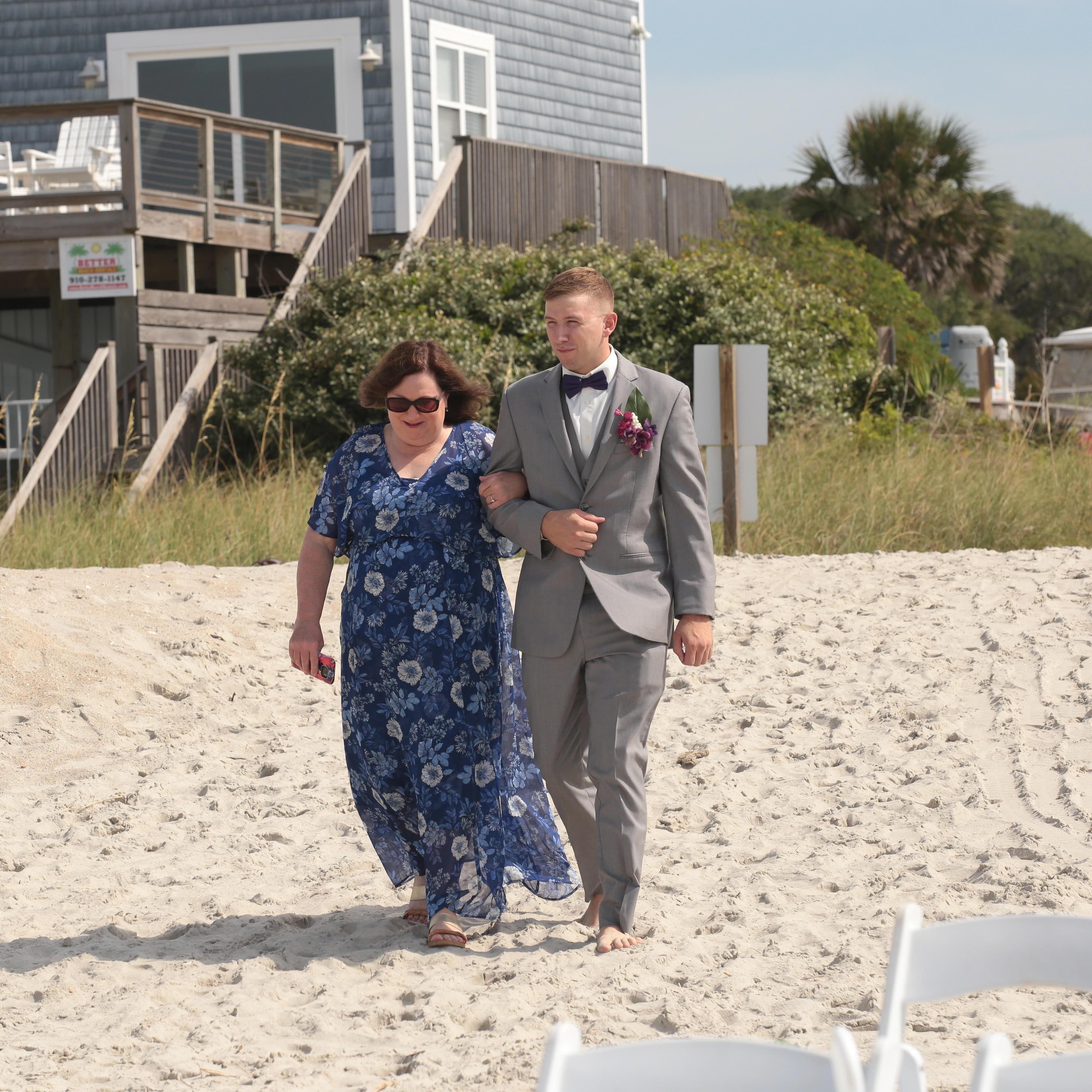 Nick walking his mother-in-law down the isle