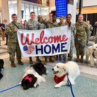 Charlie and I (Jax is in the corner) helped these Air Force personnel welcome their commander back into the States one year. That was a fun reunion.